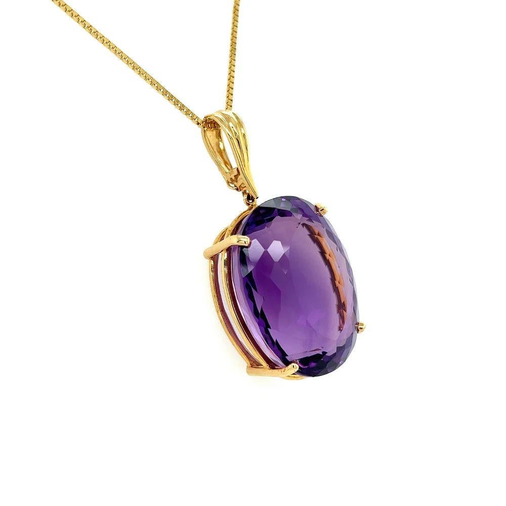 Simply Beautiful! Finely detailed Vintage 87.50 Carat Oval Amethyst Gold Solitaire Pendant Necklace. Hand crafted in 14K Yellow Gold. Suspended from a 24