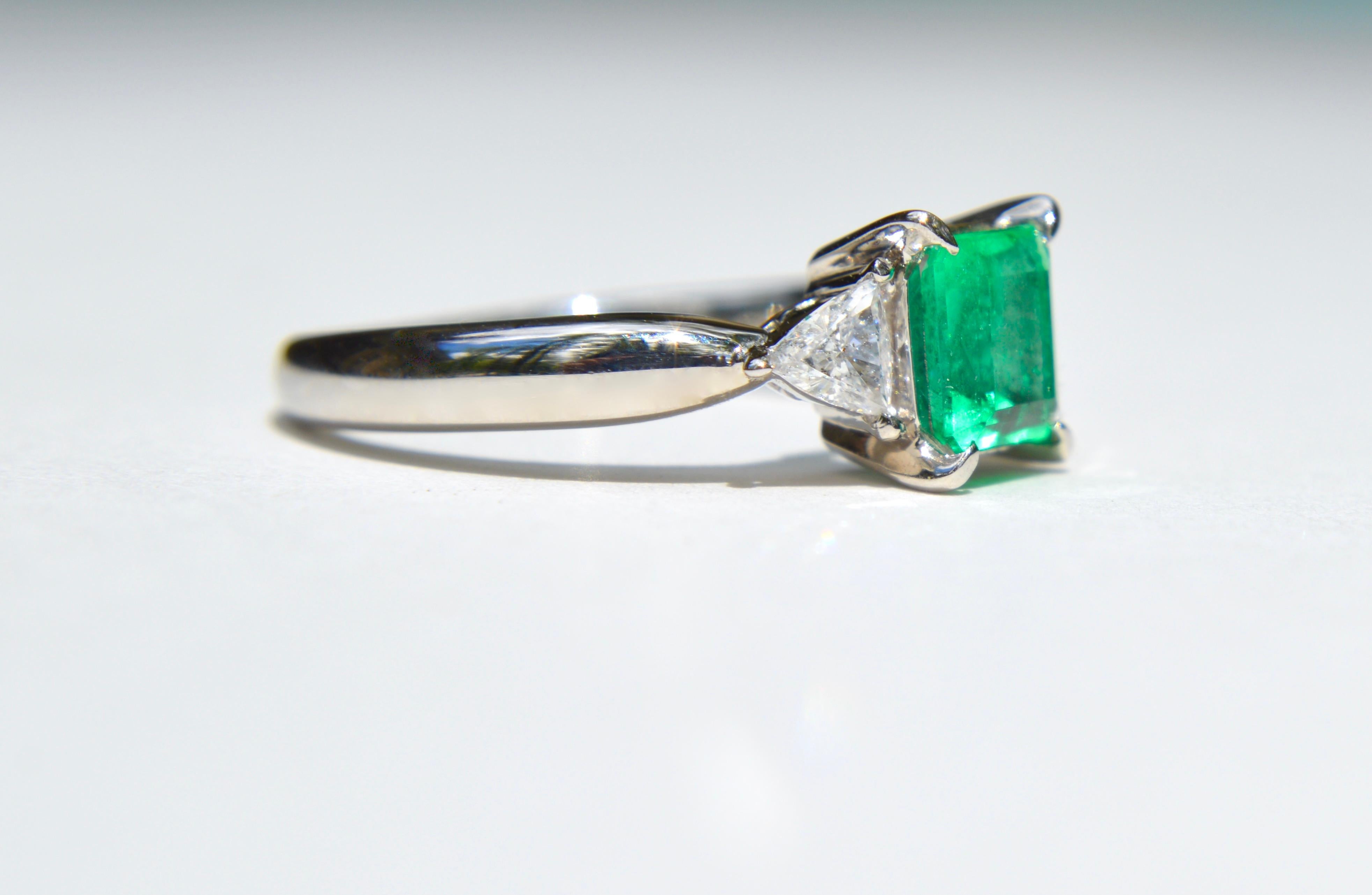 Stunning vintage Midcentury circa 1960s .88 emerald cut natural untreated Colombian emerald with trillion cut .37 carat diamonds, set in solid platinum. Size 6.5, can be resized by a jeweler. In excellent condition, Marked as Pt900 for solid