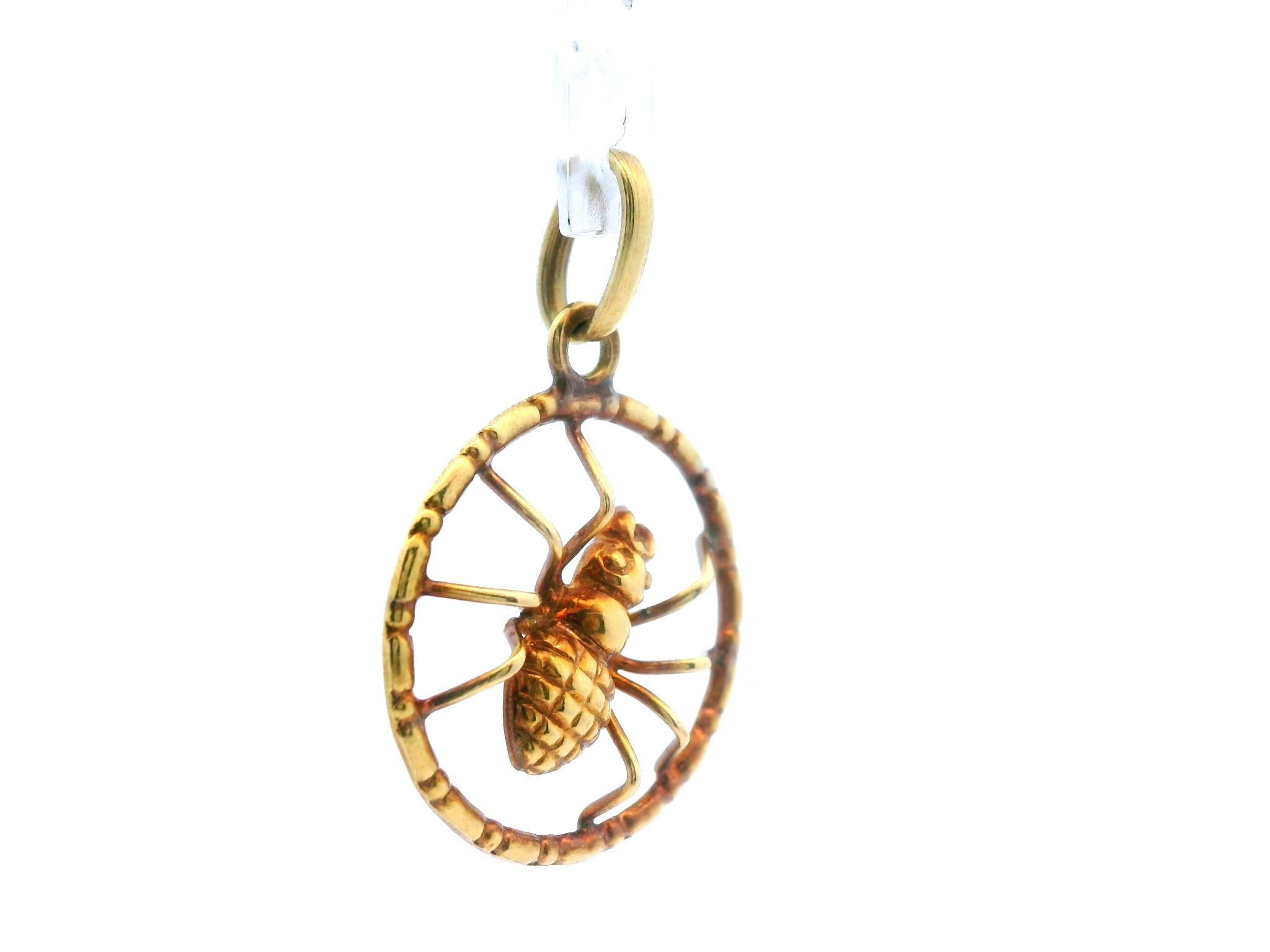 This beautiful charm/pendant is made in 18k yellow gold and features a gold spider in the center of the charm. The charm is made using a circular border that is connected to the legs of the spider. This design feature allows the spider to sit at a