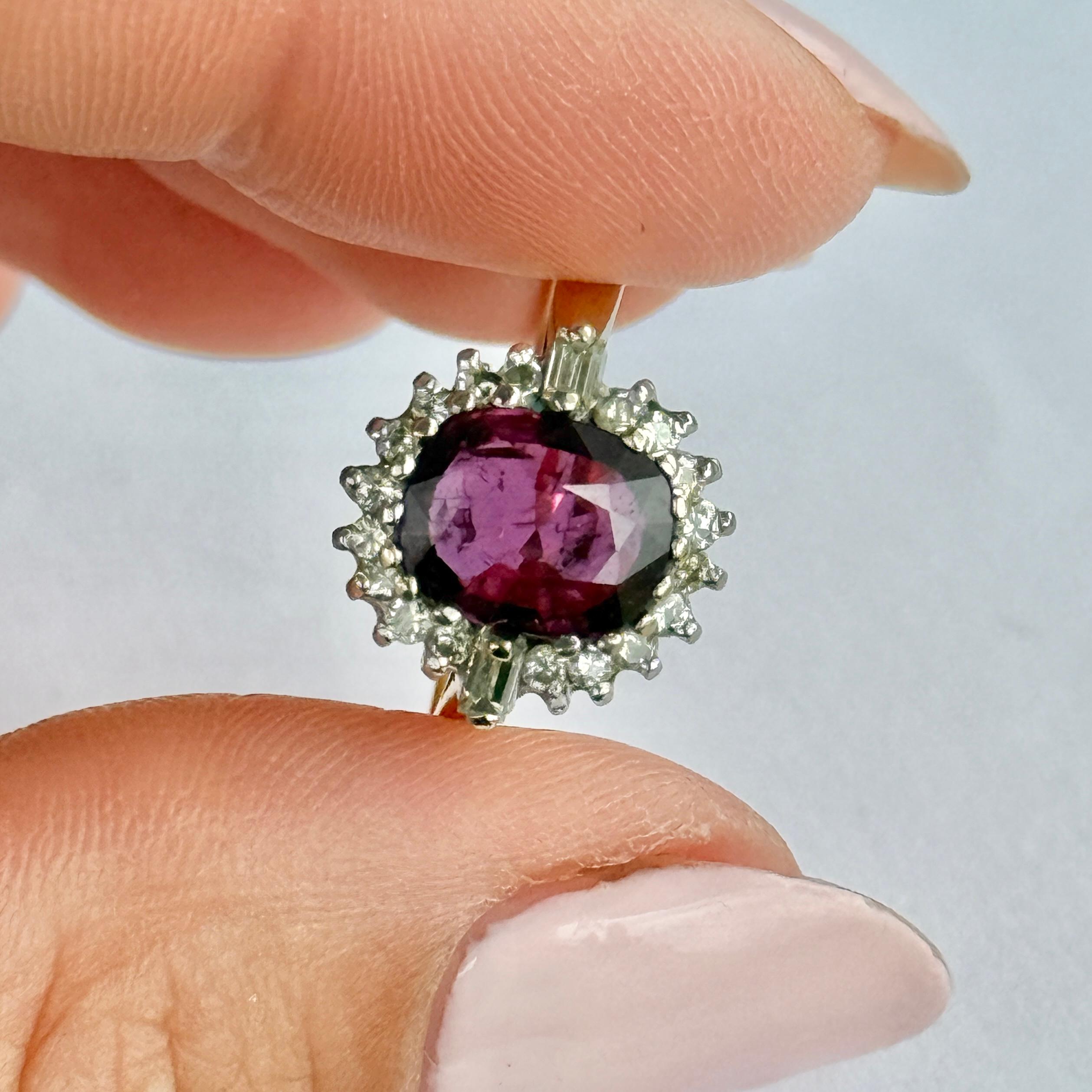 This ruby cluster ring holds a central ruby measuring 2.2 carats and either side of the gorgeous pink stone are baguette diamonds measuring 2pts each. The diamond halo totals 36pts. Stones set in platinum. Fully hallmarked London 1978.

Ring Size: 