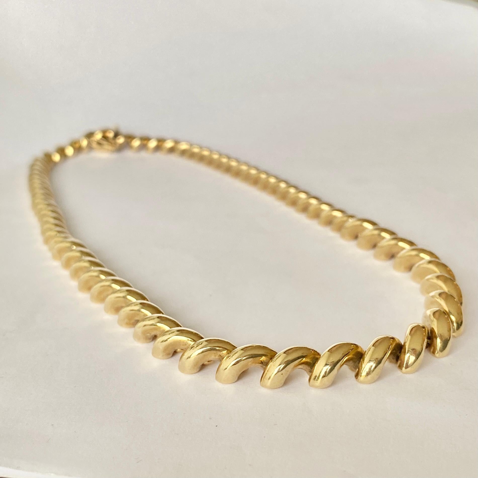 This stunning necklace has a chunky look to it and is modelled in 9carat gold. The underside of the necklace is fat so sits on the neck beautifully. The necklace is slightly graduated starting with the slimmer part of the chain at the clasp and