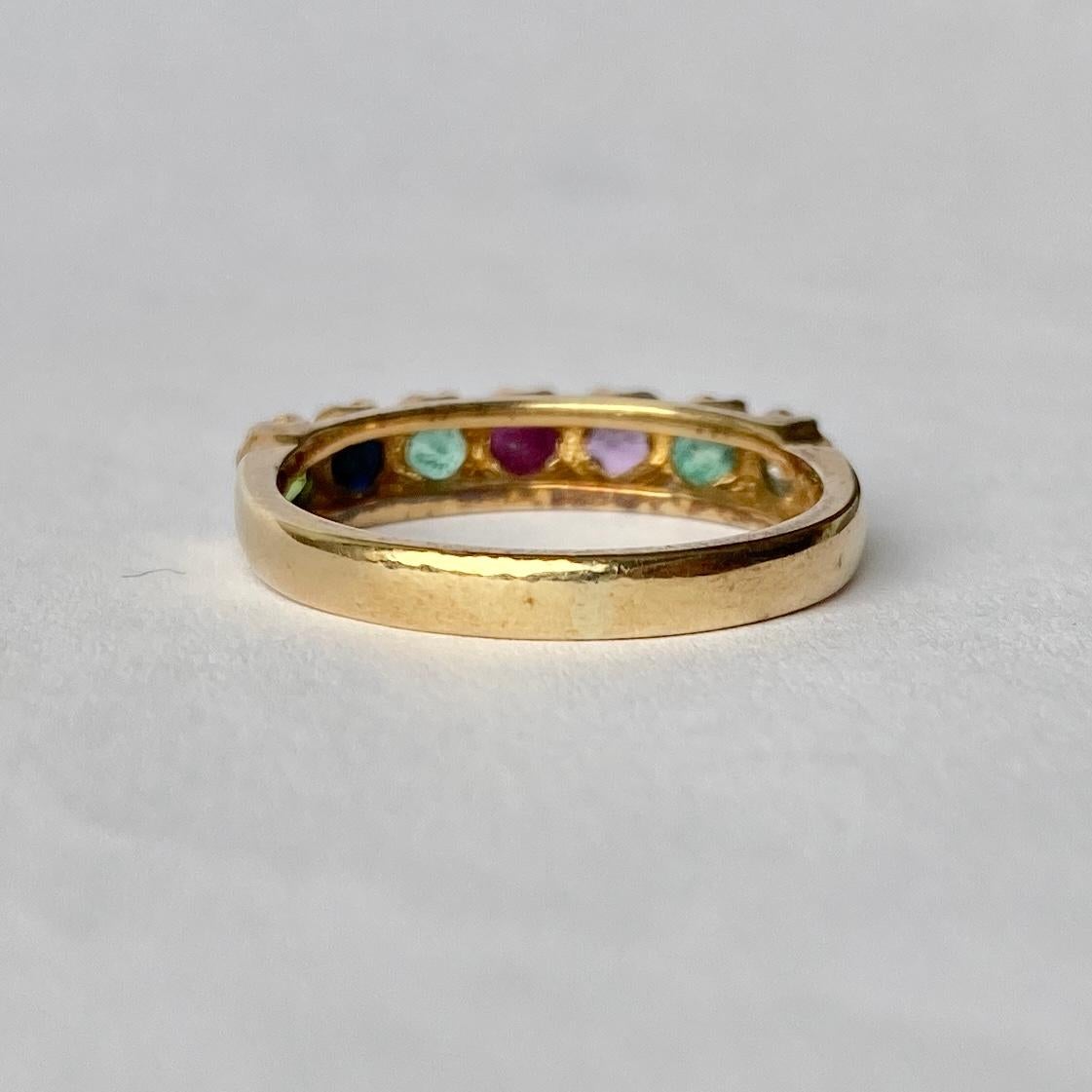 This regard ring holds a Diamond, Emerald, Amethyst, Ruby, Emerald, Sapphire and Tourmaline which spell out DEAREST using the first letter of every stone. The stones are set flush in decorative settings and the ring is modelled in 9ct gold.