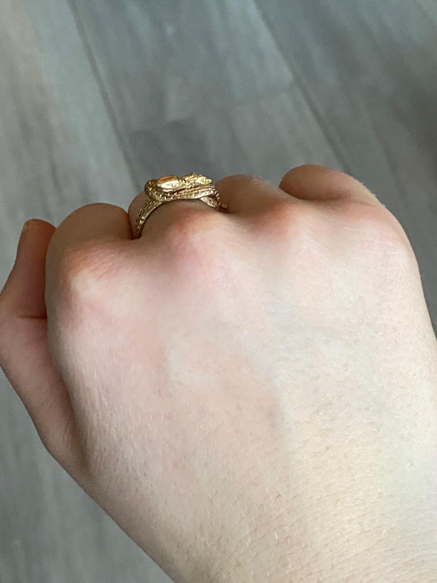 These delicate serpents have so much detail. The ring itself is modelled in 9ct gold and wraps around the finger. Fully hallmarked London 1981.

Ring Size: N or 6 3/4
Band Width: 11mm

Weight: 4.3grams
