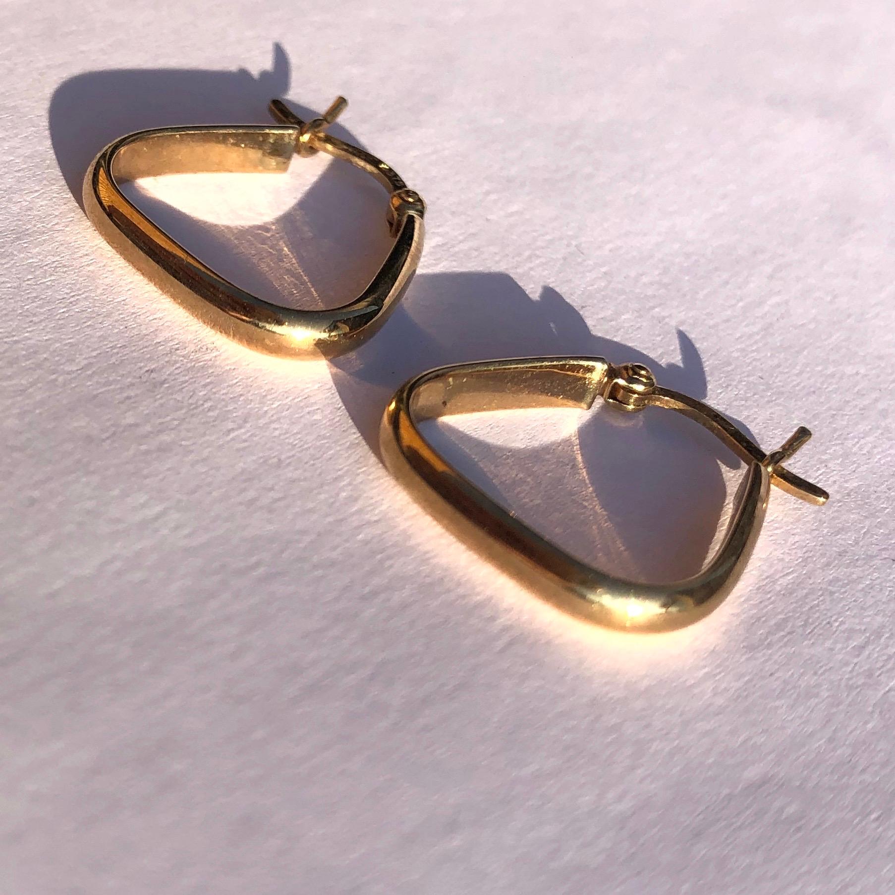 The earrings are modelled out of 9ct yellow gold and are a rounded triangle shape. They fasten with an easy push clip. 

Hoop Dimensions: 17x16mm 

Weight: 1.2g 