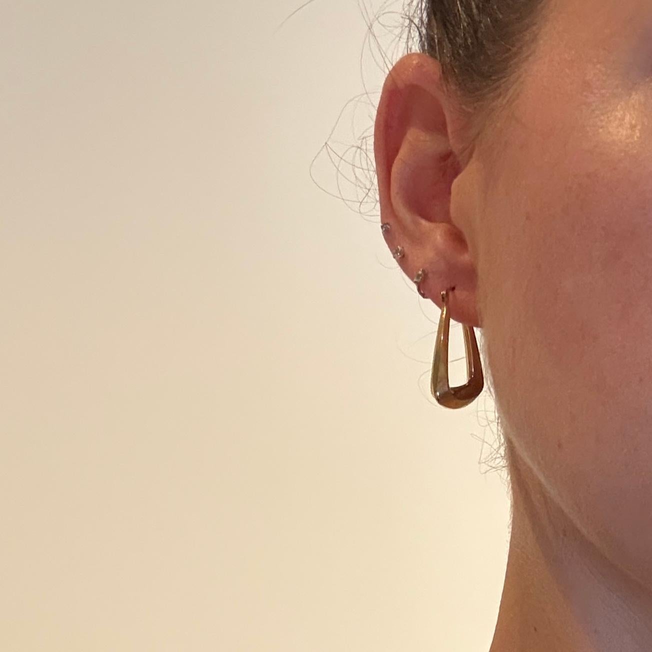 The earrings are modelled out of 9ct yellow gold and are a rounded triangle shape. They fasten with an easy push clip. The hoops are hollow so they are nice and light weight. 

Hoop Dimensions: 24x28mm 

Weight: 1.7g 