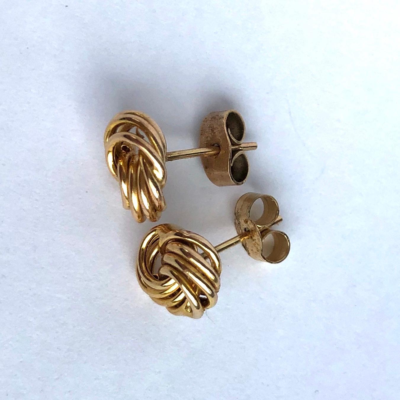 Glossy 9ct yellow gold superbly tied in a knot make the most stylish design for these earrings. The layered hoops have a wonderful sheen to them and make perfect studs. 

Knot Diameter: 9mm
Height From Ear: 4mm

Weight: 0.87g