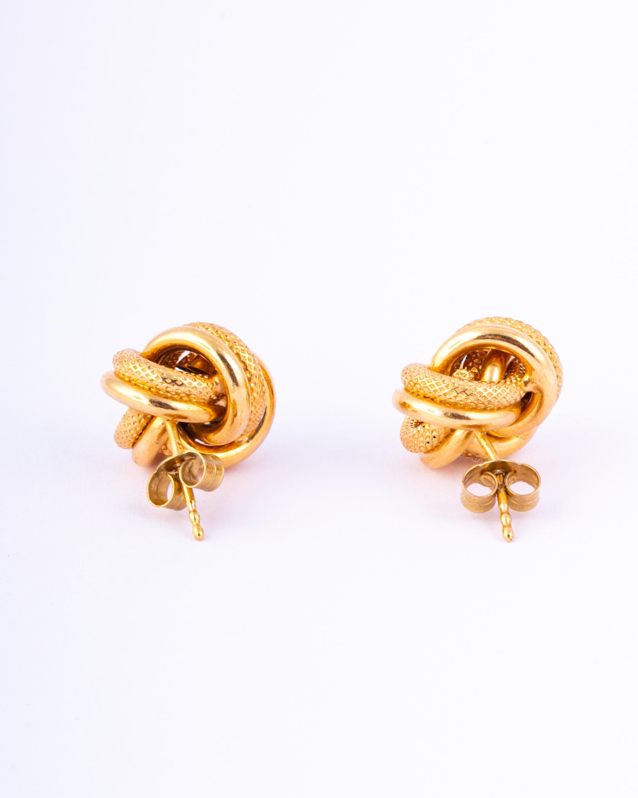 gold knot earrings on ear