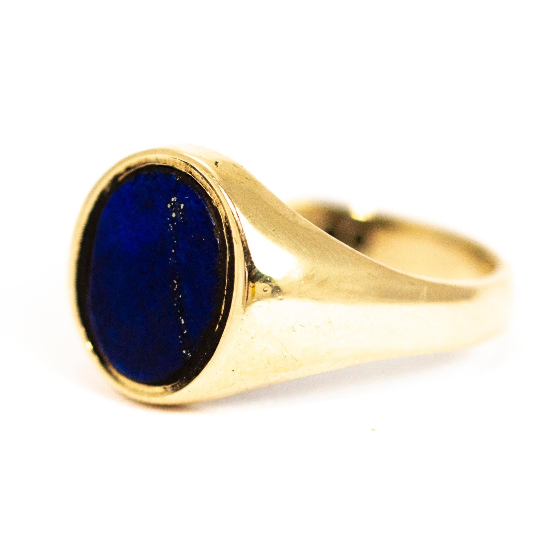 A superb vintage signet ring set with a flat cut oval lapis lazuli. The lapis has beautiful deep blue colouring with a strip of gold flecks. Modelled in 9 carat yellow gold
Fully hallmarked 1971 Birmigham, England.

Ring Size: UK N, US 7

Front