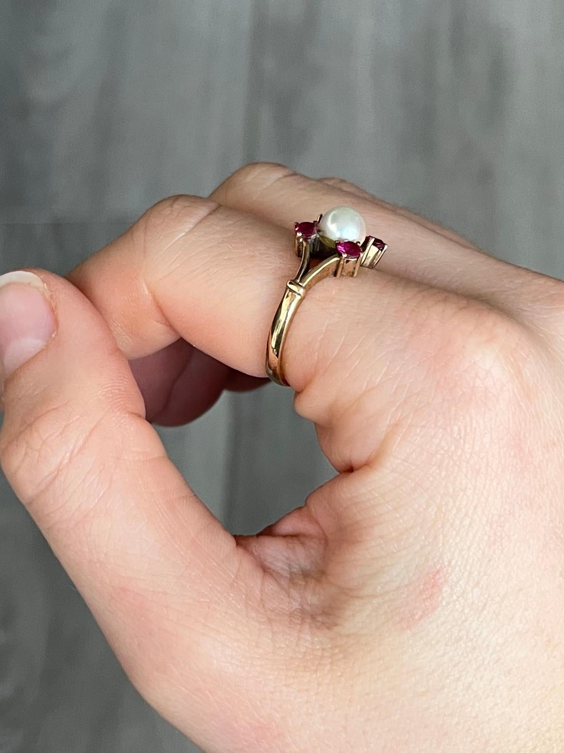 This ring holds a pearl at the centre and four rubies surrounding it. The rubies total 40pts. Fully hallmarked Birmingham 1968. 

Ring Size: N 1/2 or 7 
Face Diameter: 12mm
Height Off Finger: 7mm

Weight: 3.5g