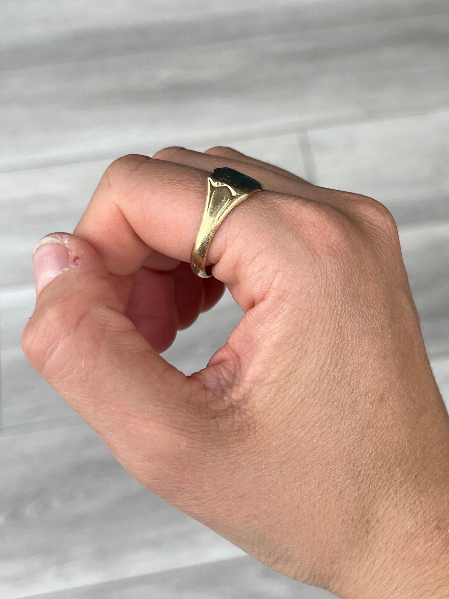 The main detail on this ring is the shield with corner engraving.  The chunky shoulders are smooth and carry on down into a plain band modelled in 9ct gold. Made in Birmingham 1964, England.

RIng Size: S or 9
Widest Part: 12mm 

Weight: 3.4g