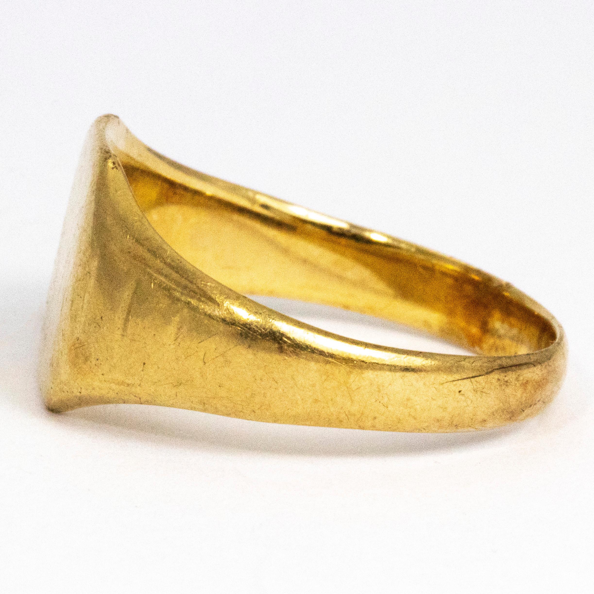 This glossy 9ct gold signet ring has a square front and the shoulders have a very faint line detail to them. The ring has a very smooth yet chunky feel to it.

Ring Size: V or 10 1/2