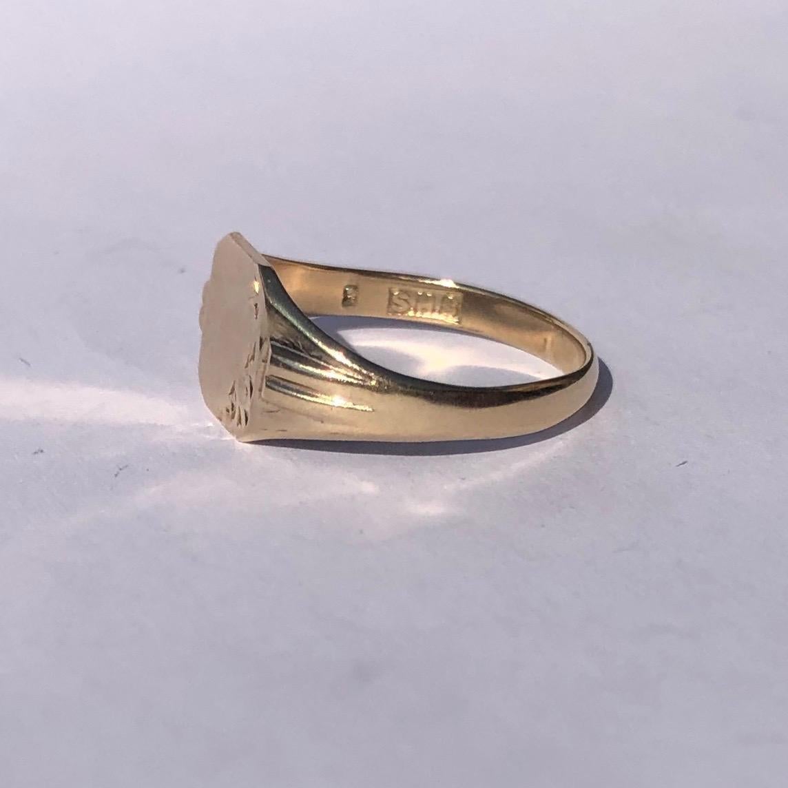 This sweet signet is modelled in 9ct gold and has a square face with half of it gently moulded with scroll detail. Made in London, England. 

Ring Size: O or 7
Face Dimensions: 8.5x8.5mm 

Weight: 2g