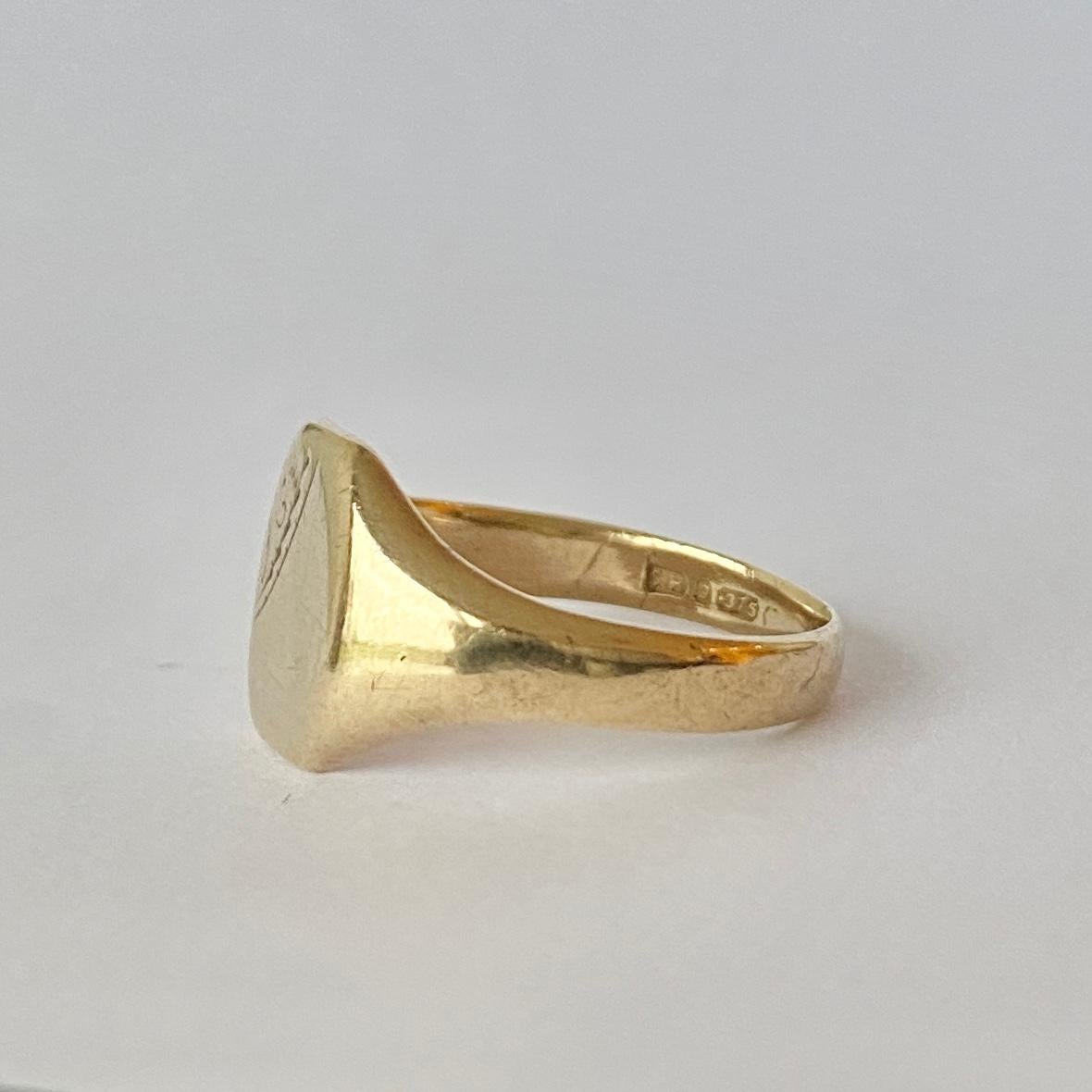 This sweet signet is modelled in 9ct gold and has a square face with half of it gently moulded with scroll detail. 

Ring Size: P 1/2 or 7 3/4 
Face Dimensions: 11x11mm 

Weight: 4.7g