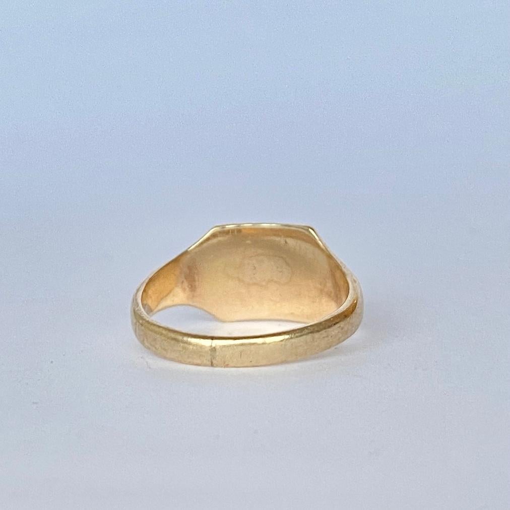 This sweet signet is modelled in 9ct gold and has a square face with half of it gently moulded with scroll detail. The initials engraved are 'E.M.K'. Fully hallmarked Birmingham 1961.

Ring Size: K 1/2 or 5 1/2 
Face Dimensions: 8.5x9mm 

Weight: