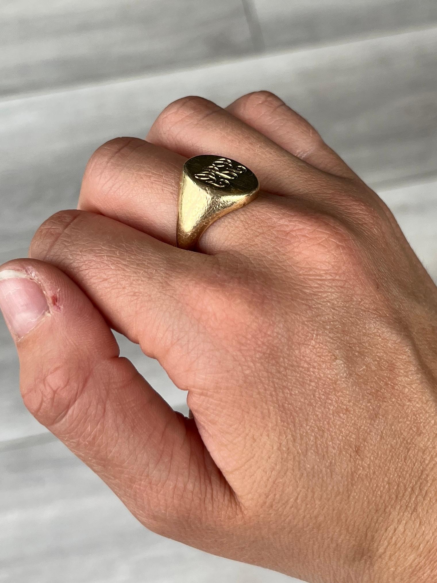 This signet is modelled in 9ct gold. The colour of the ring is bright yellow gold. Initials 'GJG' engraved onto the face. You will notice the initials are mirrored. Hallmarked London 1984. 

Ring Size: O 1/2 or 7 1/2 
Face Diameter: 15x13.5mm