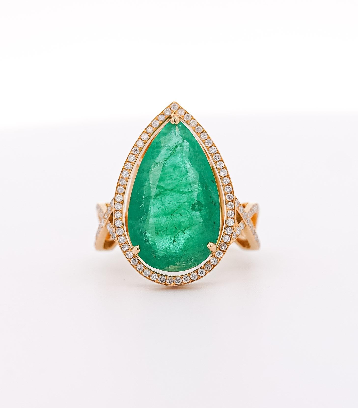 Vintage 9 Carat Zambia Emerald & Diamond Halo Ring with Jacket in 18K Gold. 

This ring is a truly exceptional piece. It features a vibrant green pear-shaped Zambian emerald, weighing 9 carats. It is secured in a prong setting and surrounded by a