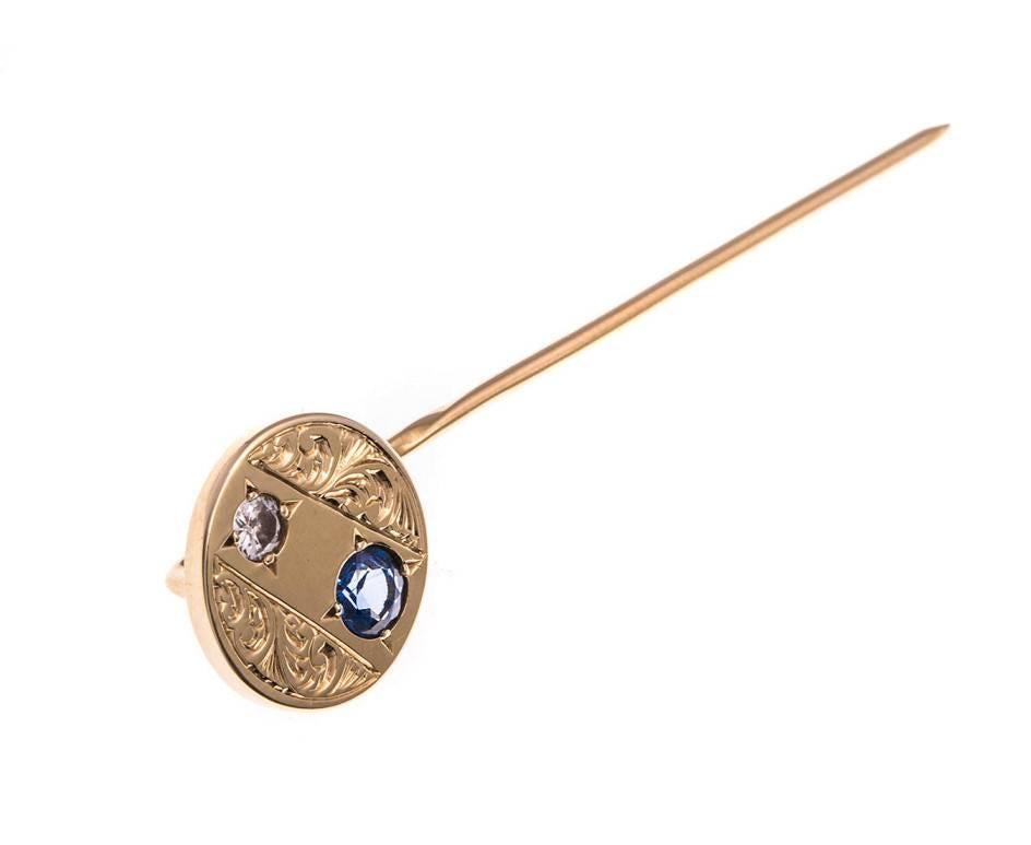 GEMMOLOGIST'S NOTES
The perfect gentlemen's accessory...a thoughtful gift for a groom on his wedding day.

Designed with a round panel, that embellished with scrolling motif accompanied by a twinkling diamond and a gorgeous blue sapphire. 

A