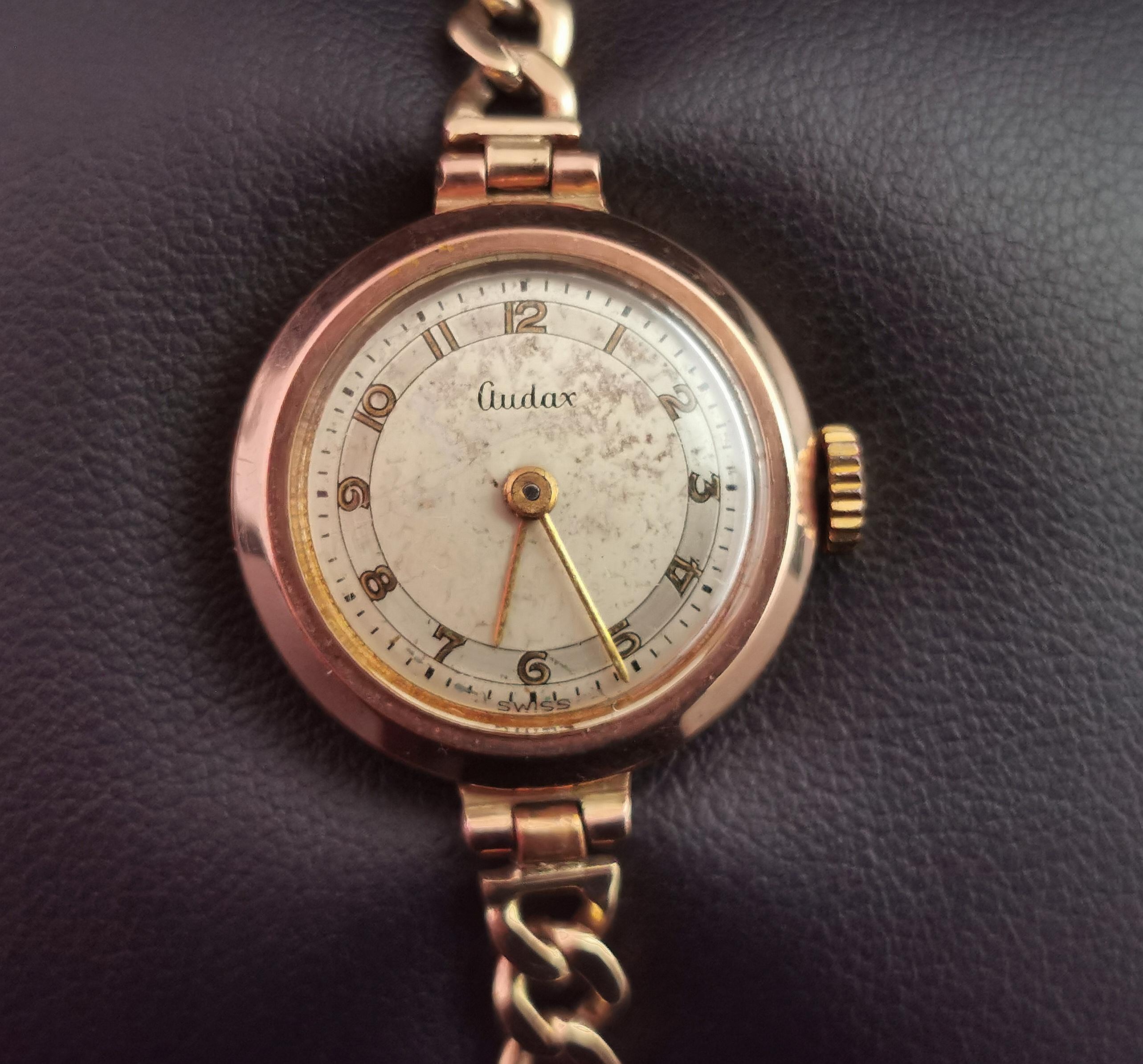 A gorgeous vintage 9kt gold ladies wristwatch.

Made by Audax it has a gorgeous vintage 9kt yellow gold curb chain bracelet strap.

Slightly rose toned yellow gold case with an off champagne enamel dial with bronze Arabic numerals and gold