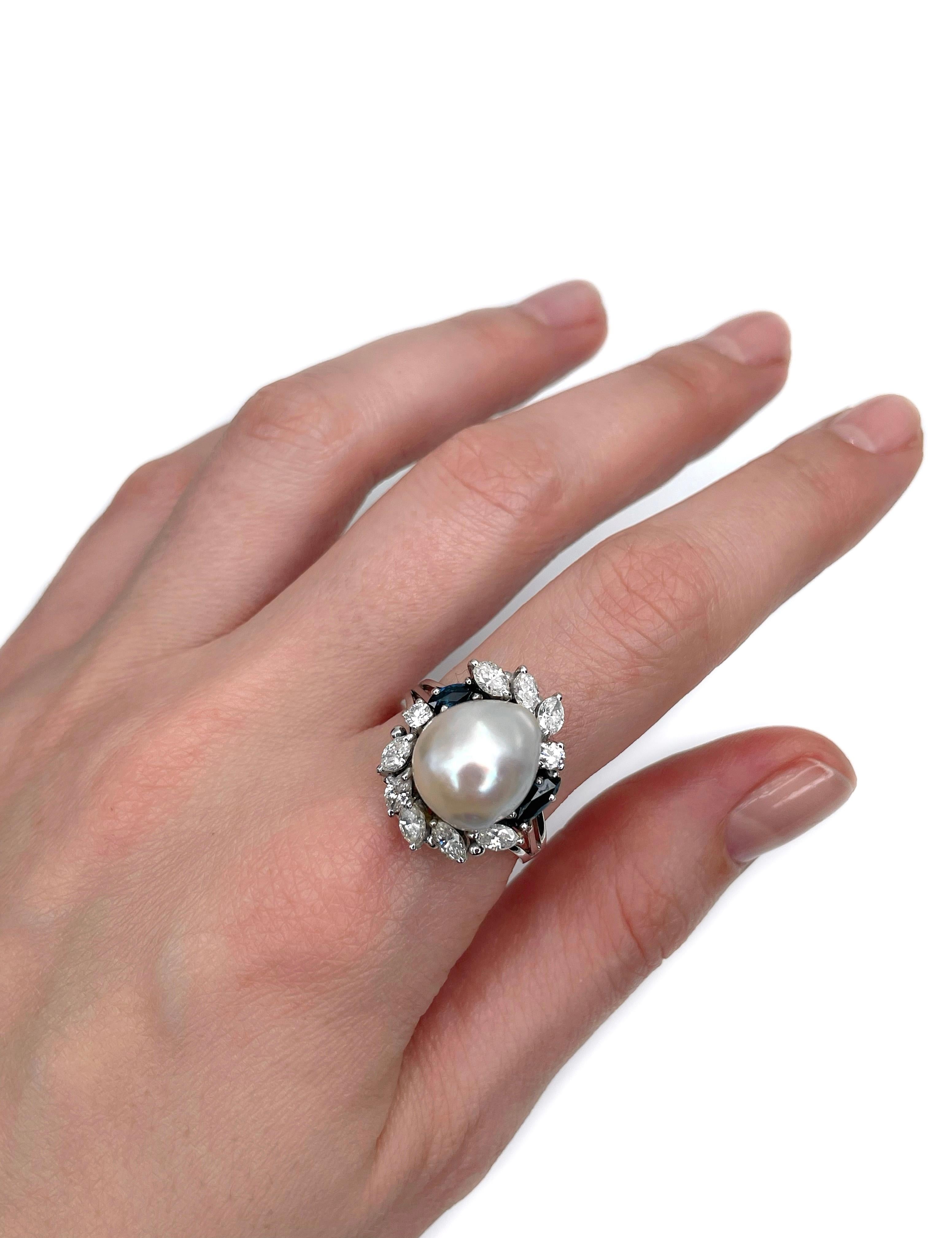 This is a modern design cocktail ring crafted in 9K white gold. Circa 1980. 

The piece features:
- 1 cultured pearl
- 10 diamonds, marquise and round brilliant cut, TW 1.20ct, RW-W, VS-SI
- 2 sapphires, marquise cut, TW 0.45ct, vB 6/4,