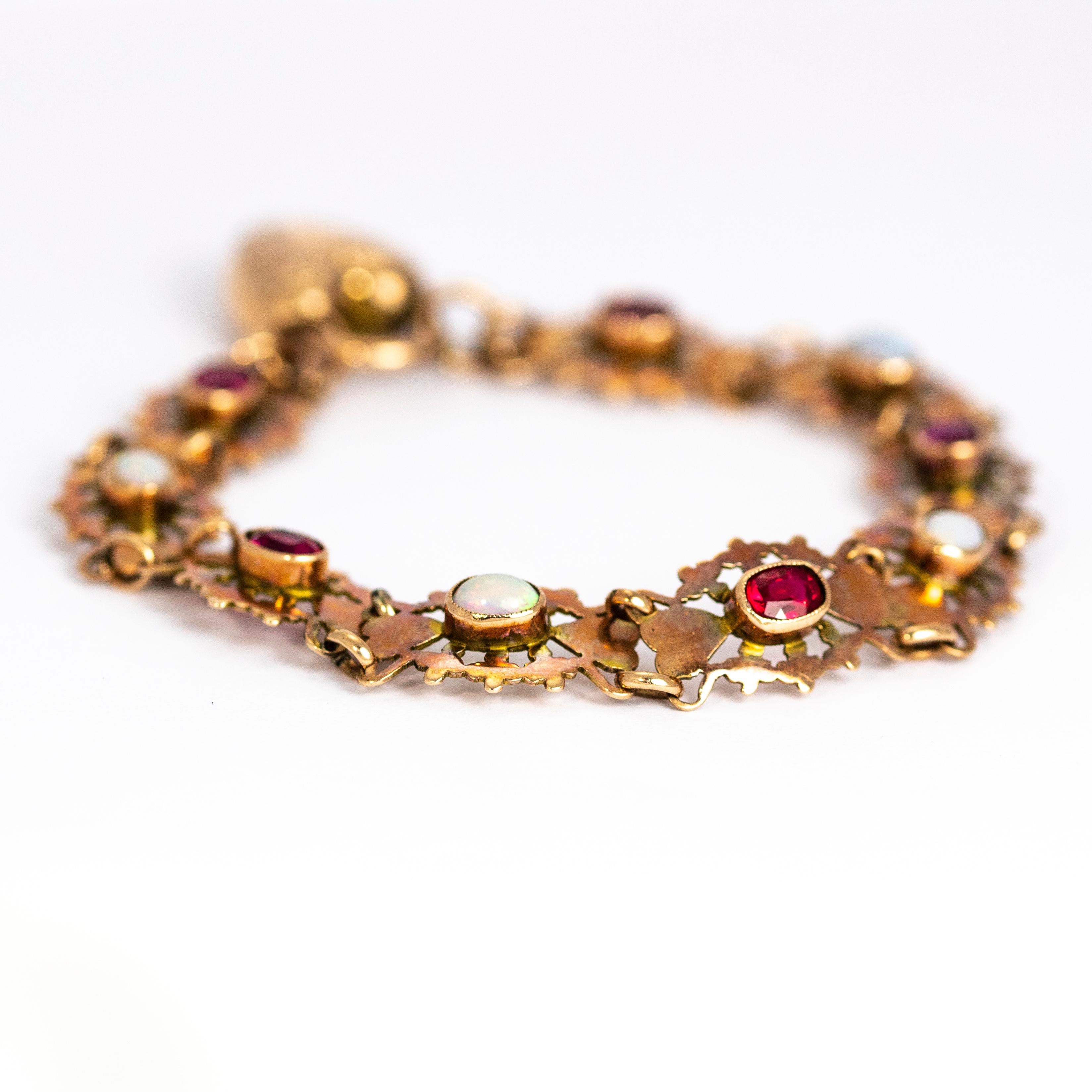 This elegant vintage bracelet is composed of nine ornate heart motif panels each set with alternating oval rubies and opal cabochons. Finishing with a ornate chunky heart padlock clasp. Modelled in 9 karat rose gold.

Length: 18.3 cm

Width: 1.2 cm
