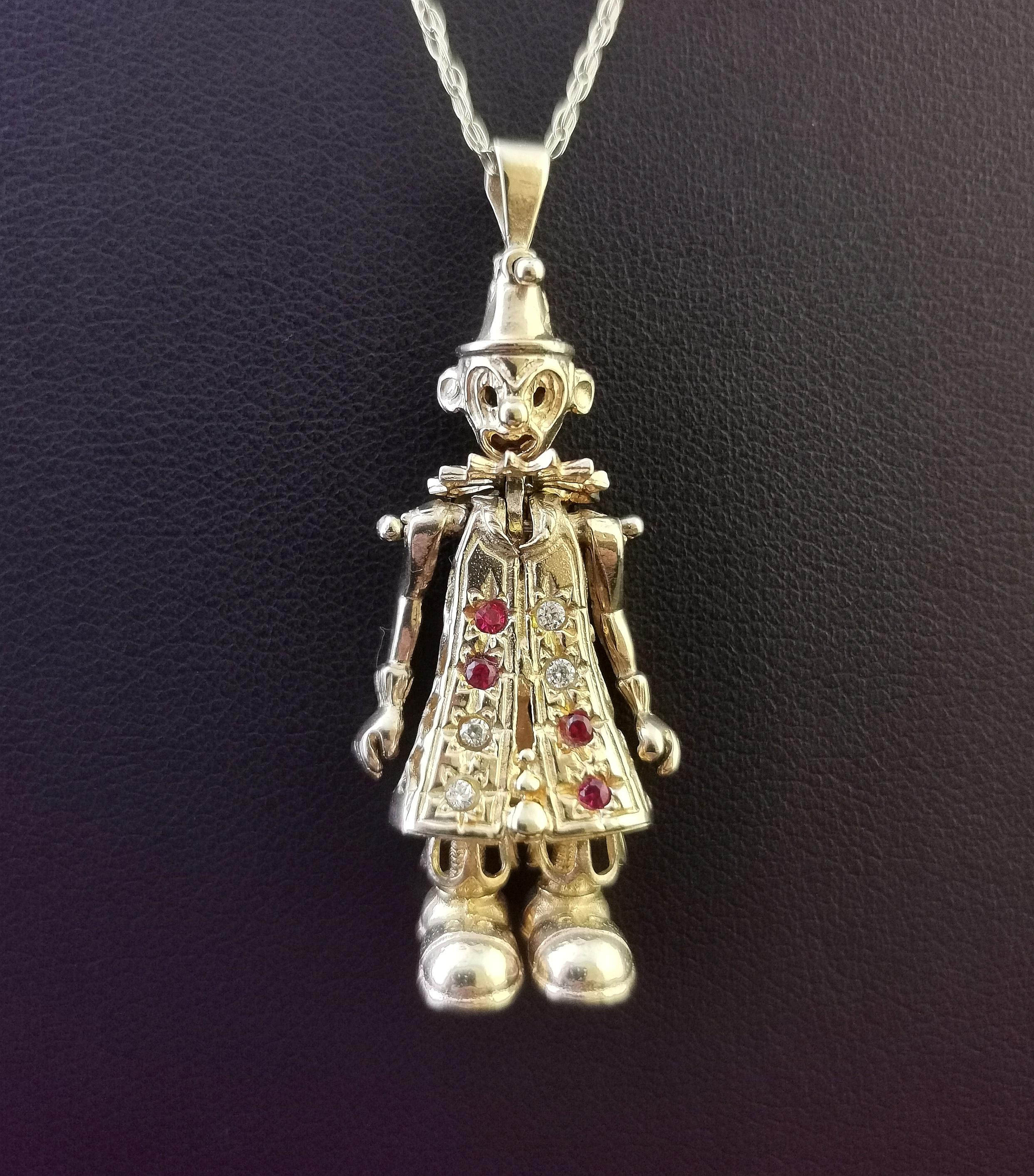 A fantastic vintage 9kt yellow gold articulated clown pendant.

A classic favourite from the 90s this clown pendant has movable limbs and is set with red paste and cubic zirconia stones to the front.

A great novelty piece, it comes on a fine link