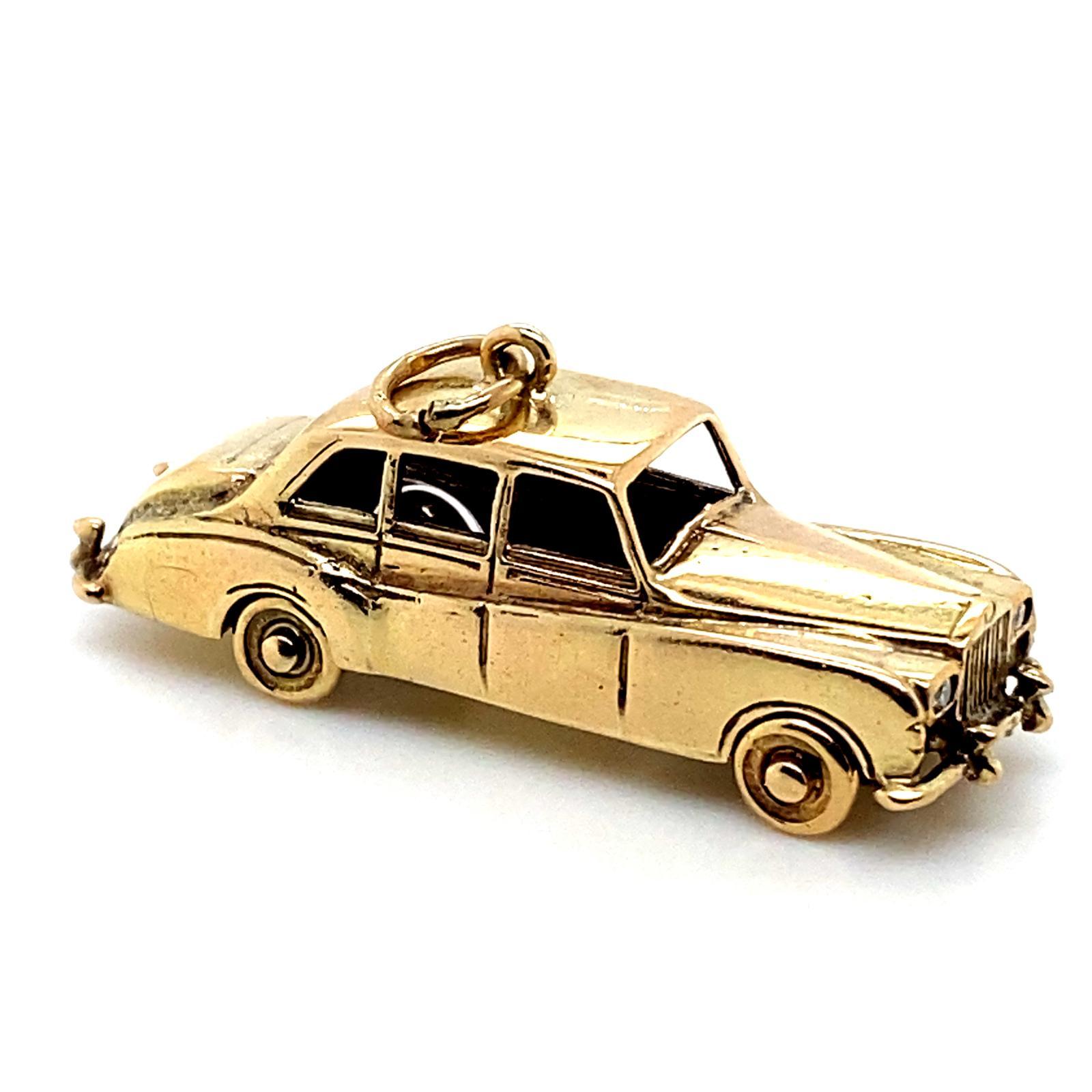 A vintage 9 karat yellow gold Rolls Royce diamond set charm, circa 1980.

Realistically modelled as a classic Rolls Royce set to its headlights with round brilliant cut diamonds of 0.08cts in total, assessed as H/I colour, VS2 clarity, and with the