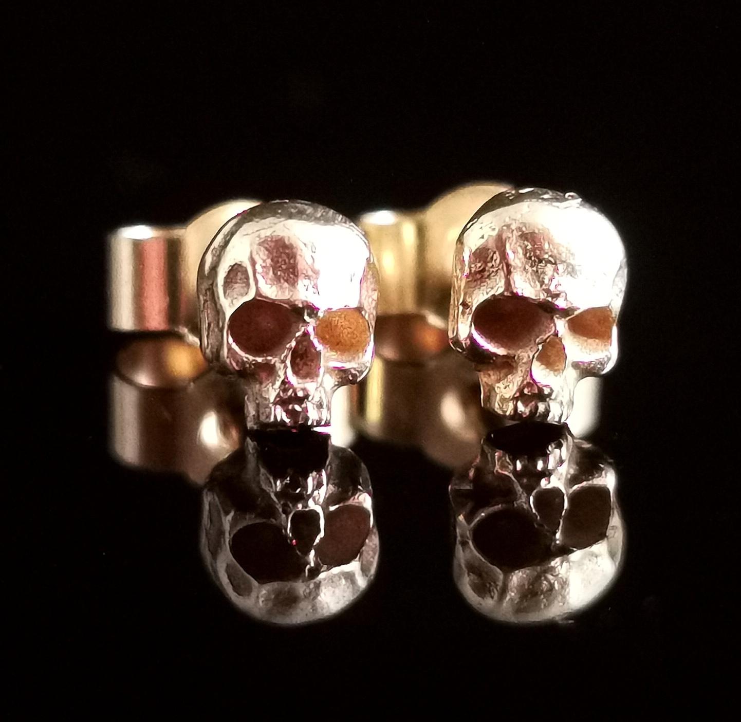 A fantastic, Dainty pair of vintage 9kt yellow gold skull earrings.

Crafted in solid 9kt gold they are designed as teeny tiny little skulls with realistic detailing each affixed to a 9kt gold Post.

They are both stamped 375 for 9ct gold.

This