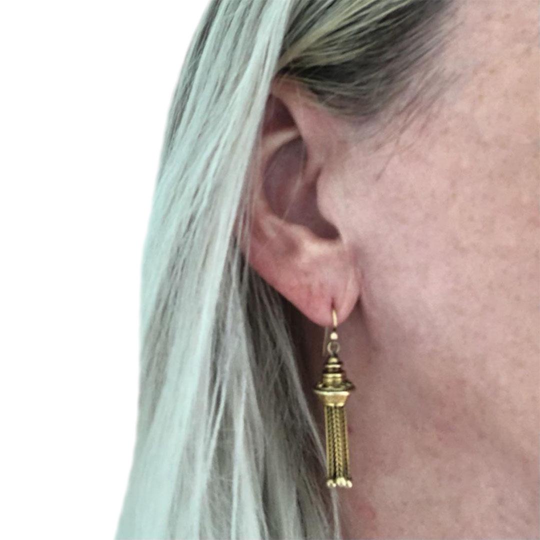 An attractive vintage pair of 9ct yellow gold tassel drop earrings made in 1967 made in the Etruscan style still popular in the period. Fitted with foxtail link tassels with ball terminals, the decorated chased caps complete the design of these