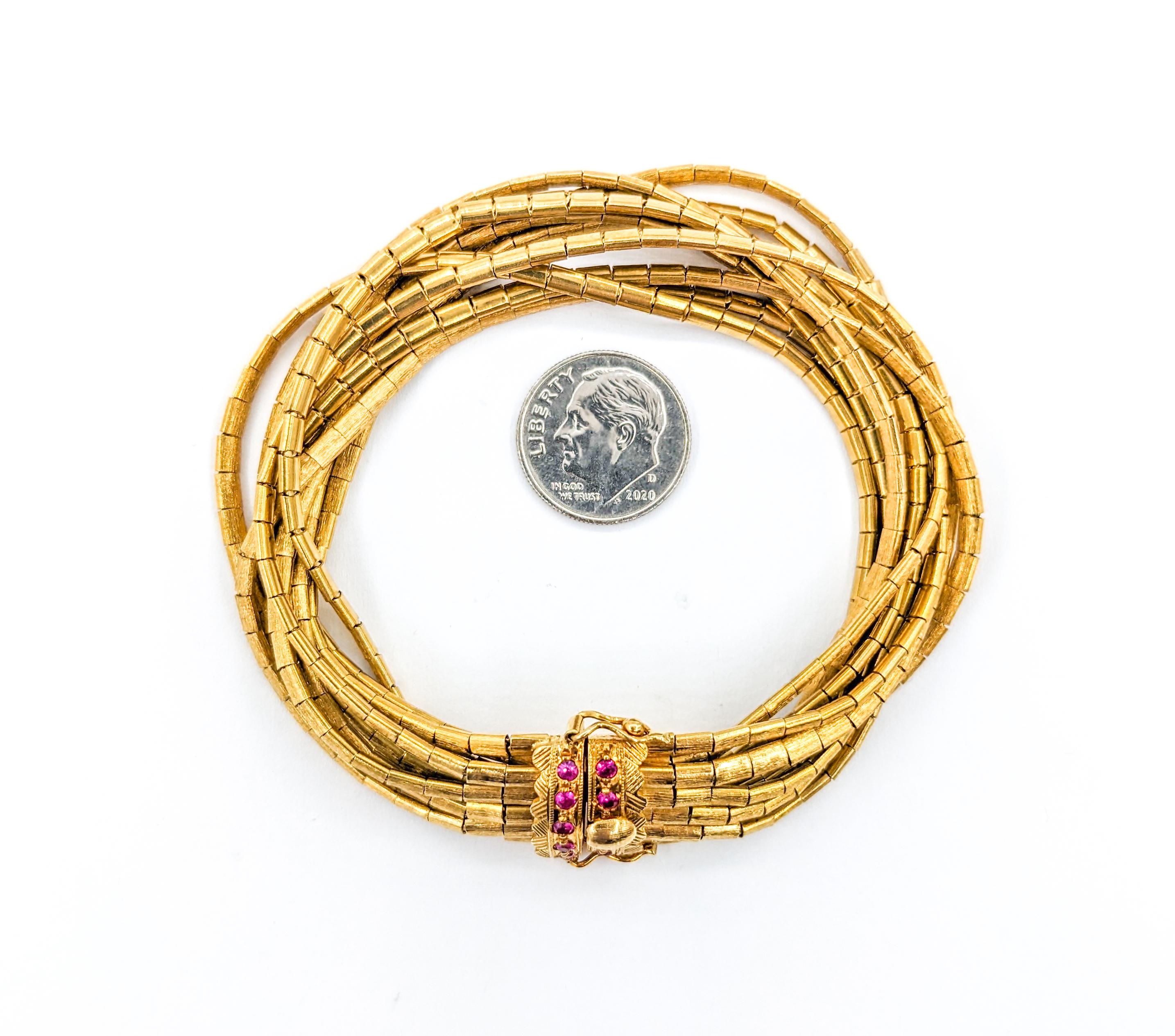 Vintage 9-Strand Ruby Bracelet In Yellow Gold

Behold the grandeur of our Vintage 9-Strand Bracelet, a testament to timeless design and opulence, forged in 18kt yellow gold. It boasts a quarter-carat total weight of radiant rubies, each one selected