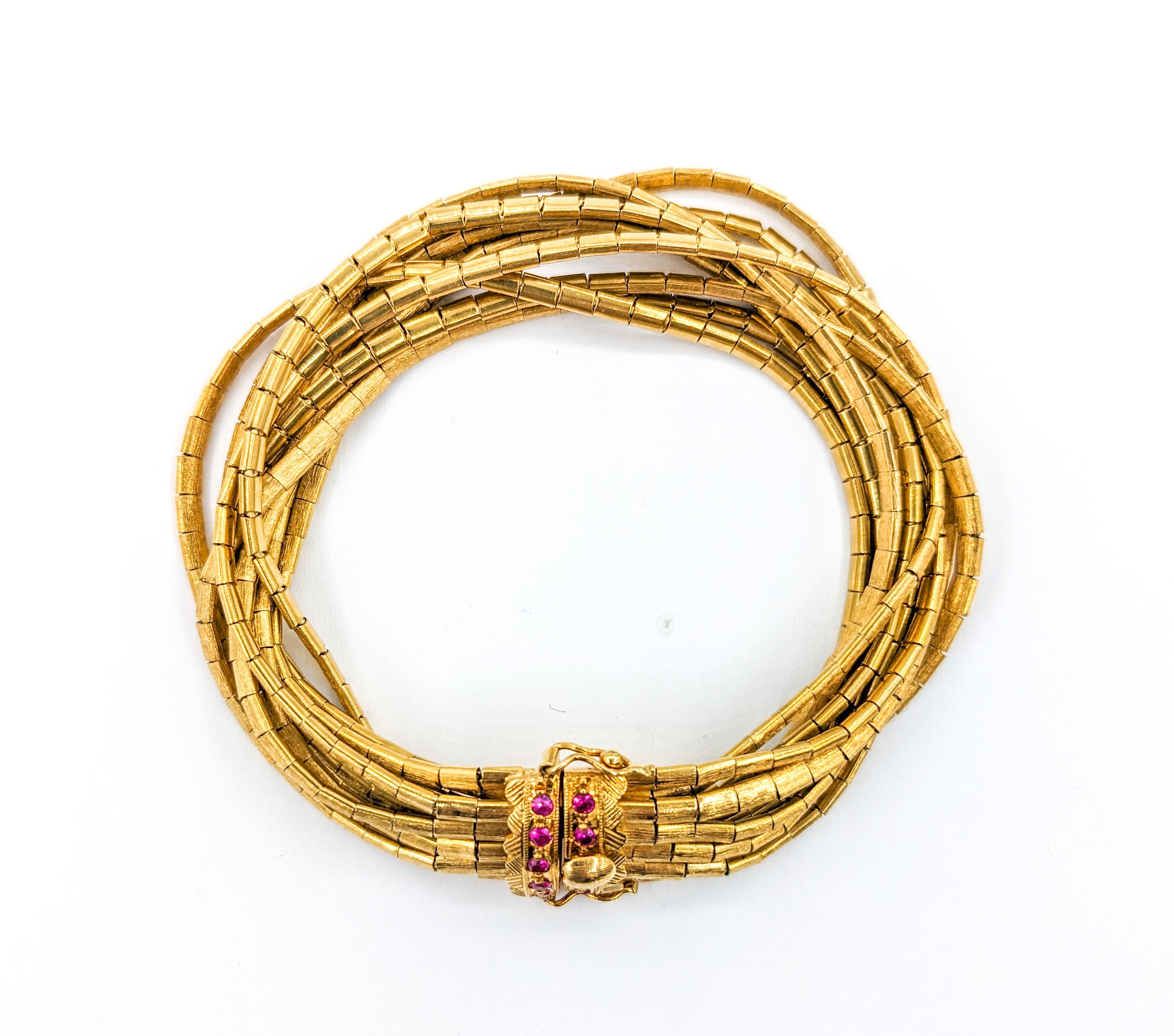 Modern Vintage 9-Strand Ruby Bracelet In Yellow Gold For Sale