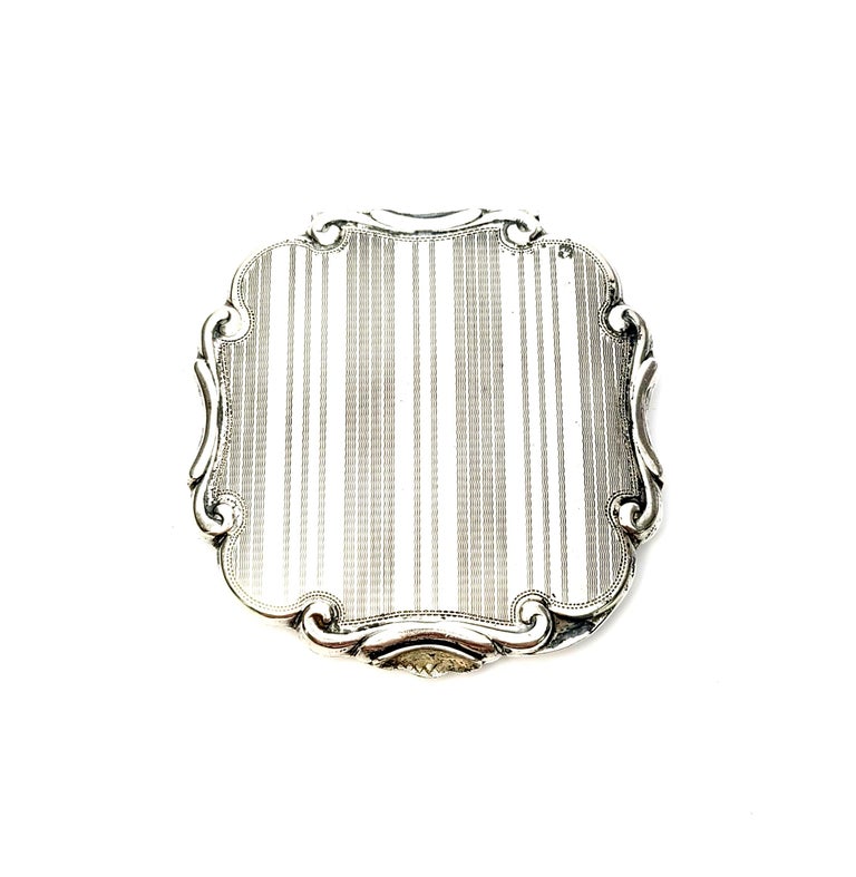 Vintage sterling silver compact.

Beautiful etched floral and leaf motif on one side, etched stripes on other side.

No monogram, there is a blank polished space on the flowered side which could be used for a monogram.

Measures: 3 1/2