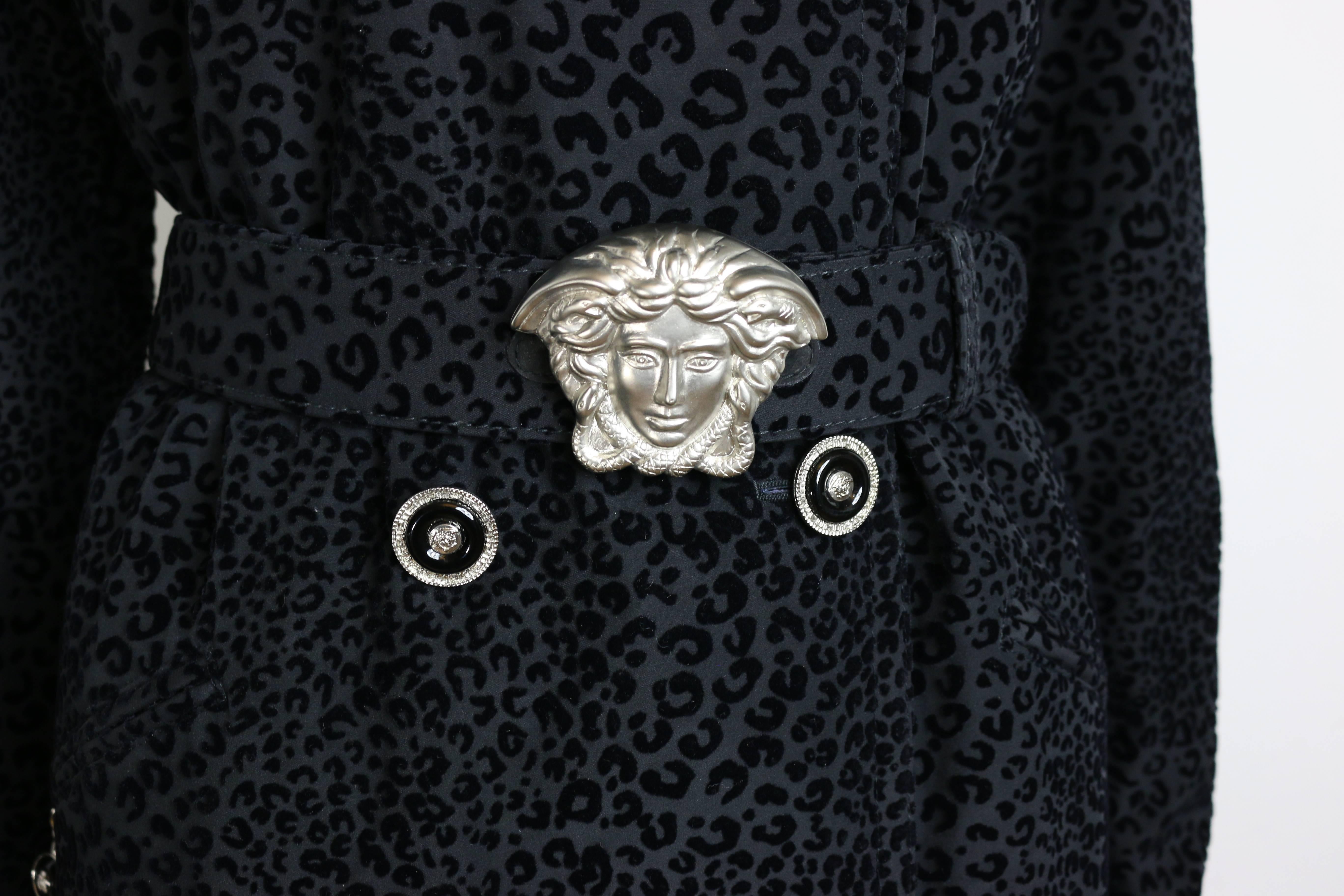 - 90s Gianni Versace black leopard-print double breasted coat. 

- Straight line cutting style. 

- Featuring iconic Medusa head belt buckle. 

- Featuring eight iconic Medusa head logo buttons on front and two Medusa head logo buttons on each
