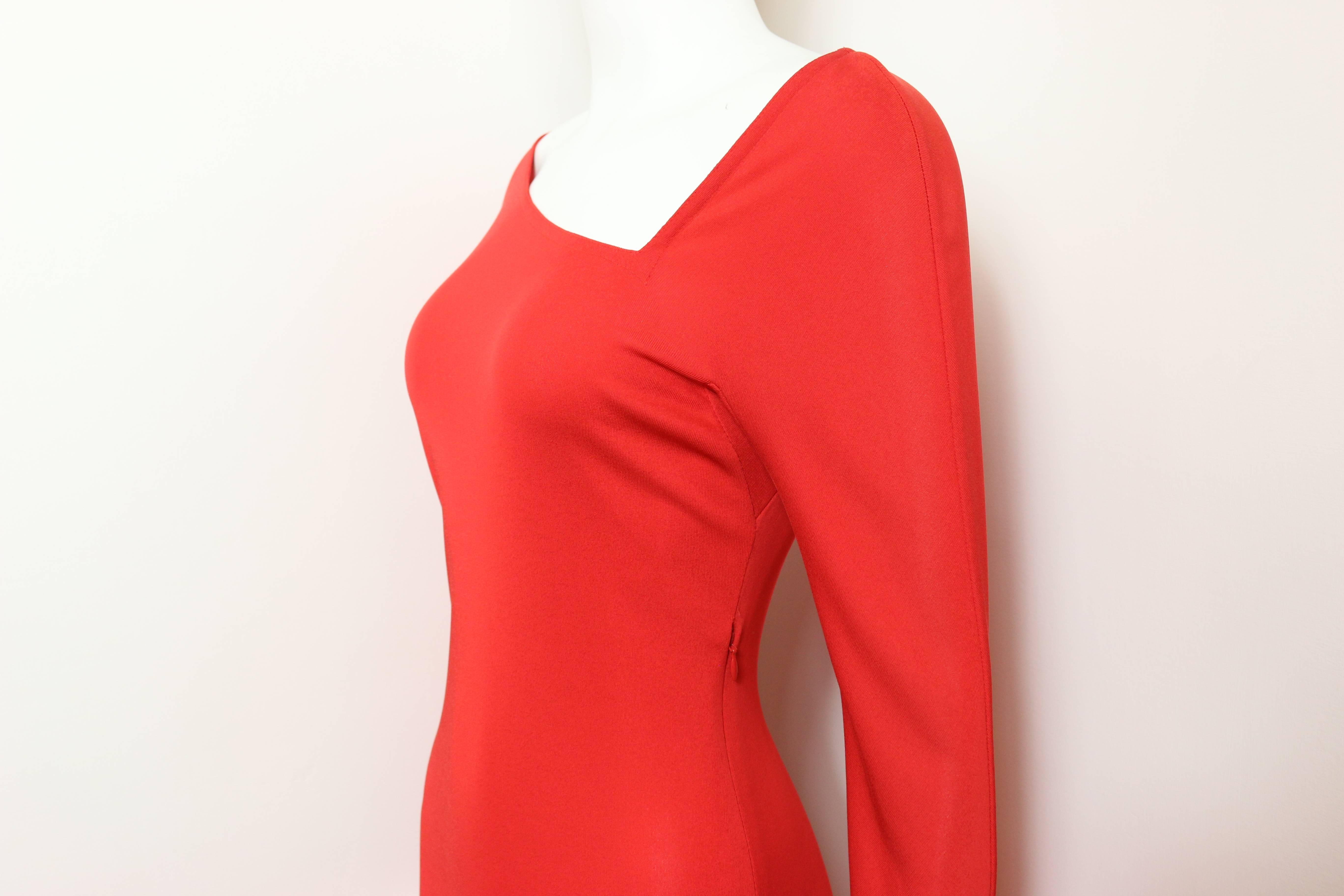 - Vintage 90s Gianni Versace couture red asymmetric dress. 

- Cut out asymmetric detail neckline.

- Knee length asymmetric hemline.

- Fire red long sleeves stretch jersey dress.

- Zipper on the side. 

- 97% Rayon, 3% Silk. 

- Size 42. 
