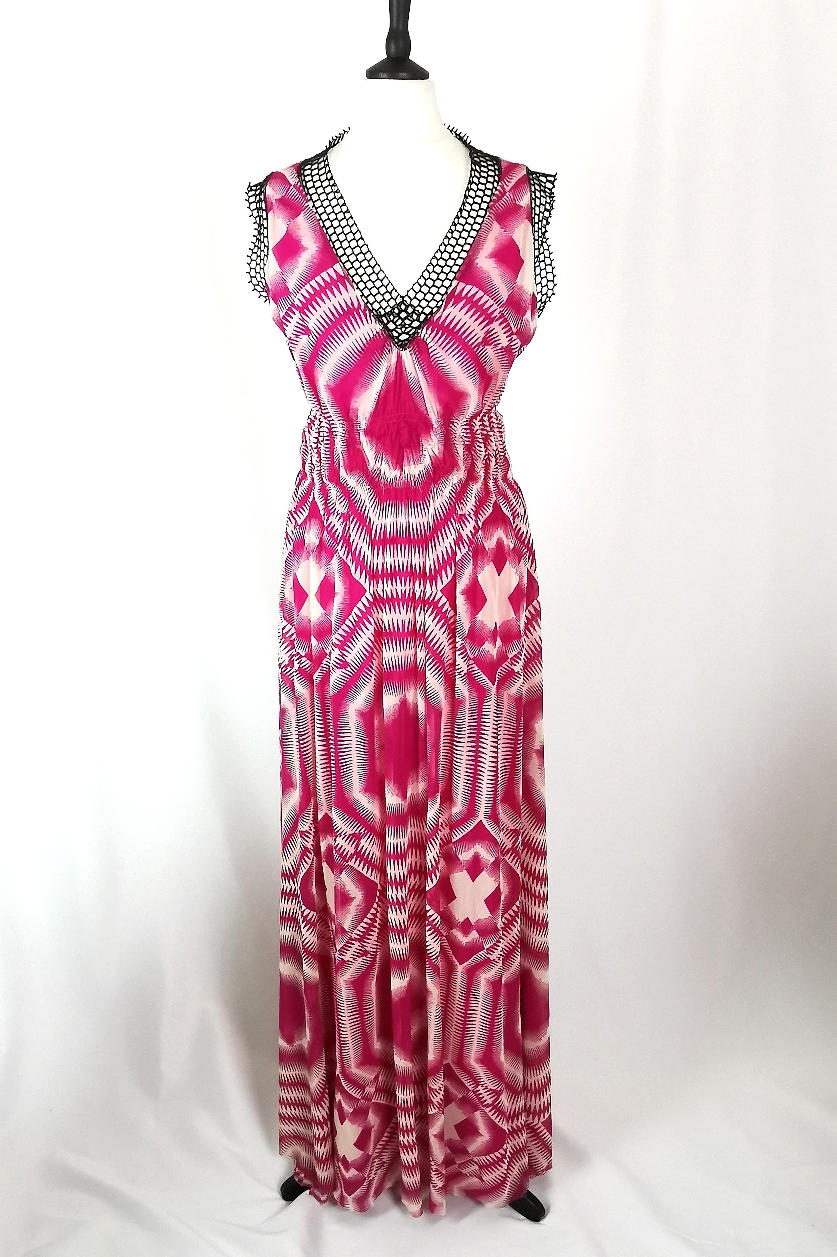 An iconic vintage Jean Paul Gaultier Soleil maxi dress.

It is made from a lovely lightweight synthetic chiffon, fully lined skirts and has an all over abstract tie dye style print in a vibrant magenta, such a popular 90s festival style.

It has a