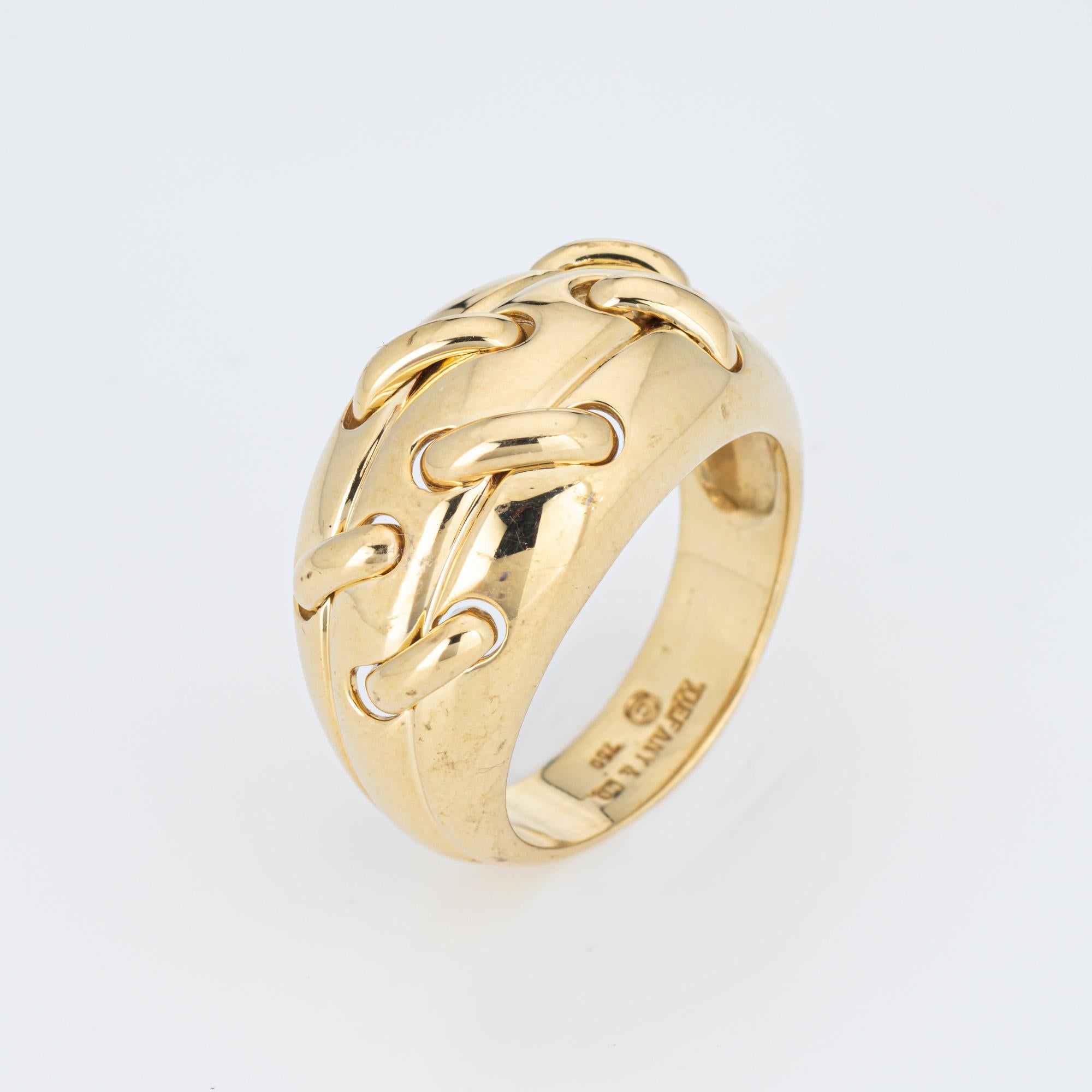 Vintage Tiffany & Co 'Stitch' ring crafted in 18 karat yellow gold (circa 1990s).  

The domed band features a thread like design that is 'stitched' in an off-center position. A striking and unique design that makes a statement. The low rise band
