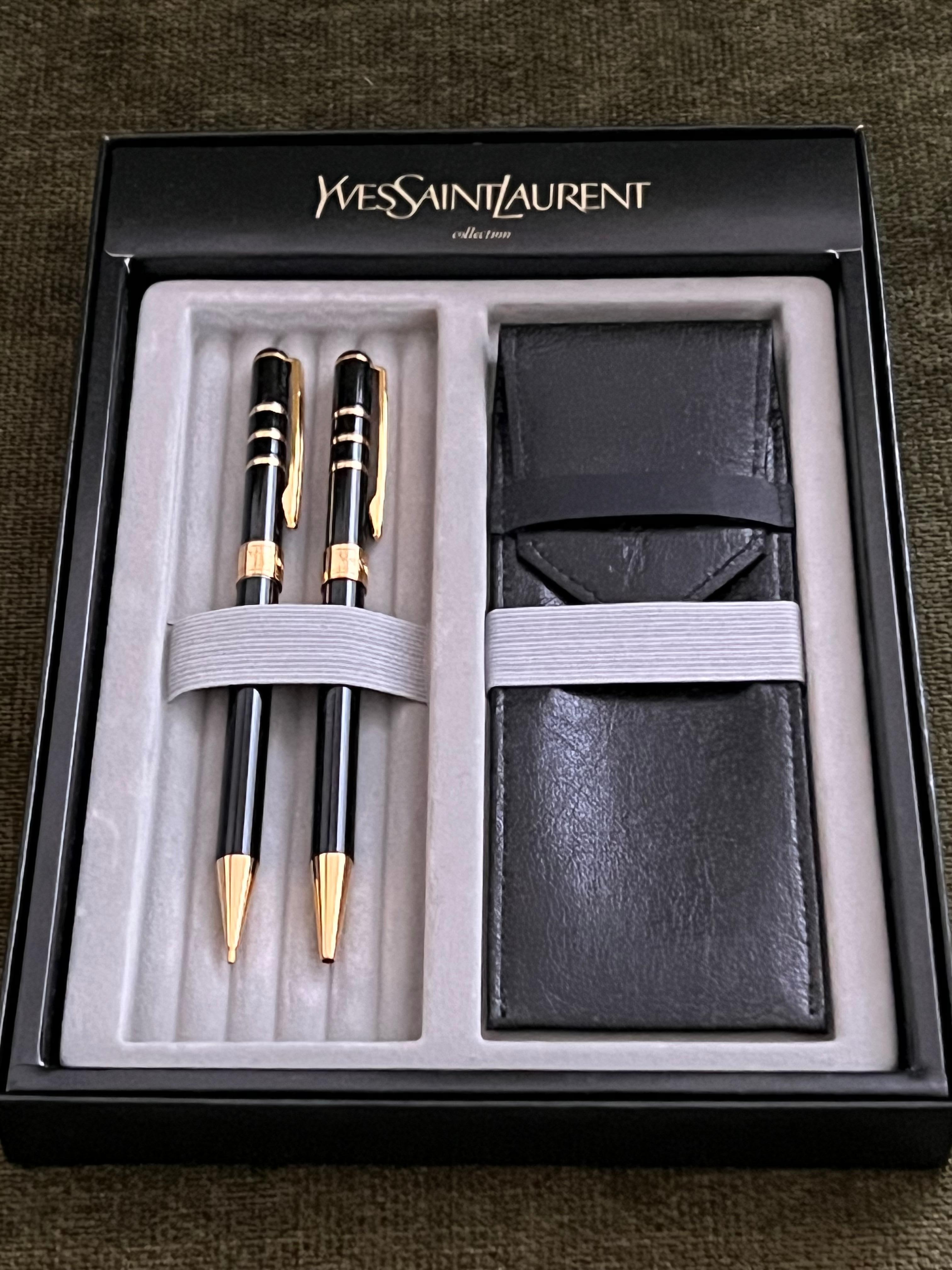 A vintage from the now rare YSL pen series of the 1990s. Never been used. 
Yves Saint Laurent YSL Ballpoint Pen & Mechanical Pencil & Leather Case 
It is a stunning writing instruments. 
Slim and easy to hold, it adorns a plain monogrammed gold