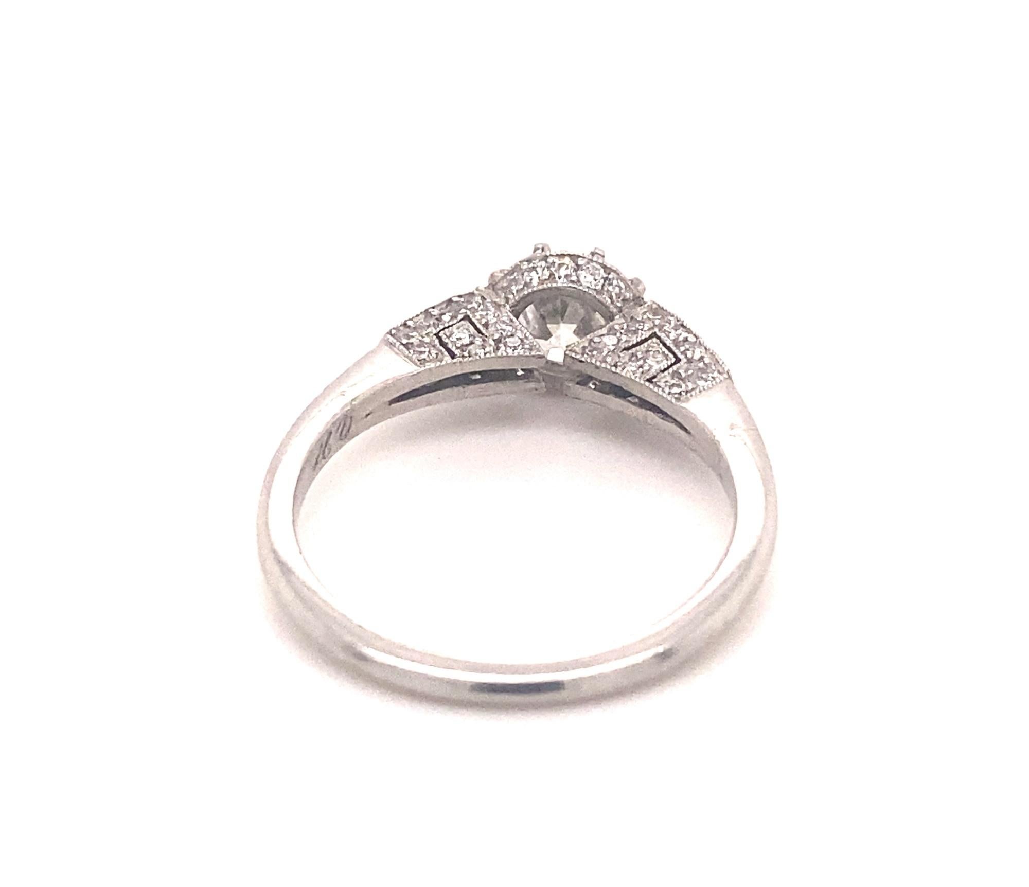 This is a beautiful vintage engagement ring set with a .91 transitional cut diamond.  The setting has an intricate design with 56 pave diamonds I color VS-2 clarity total diamond weight 1.47 carats.  The center diamond is H-I color SI-1 clarity. 