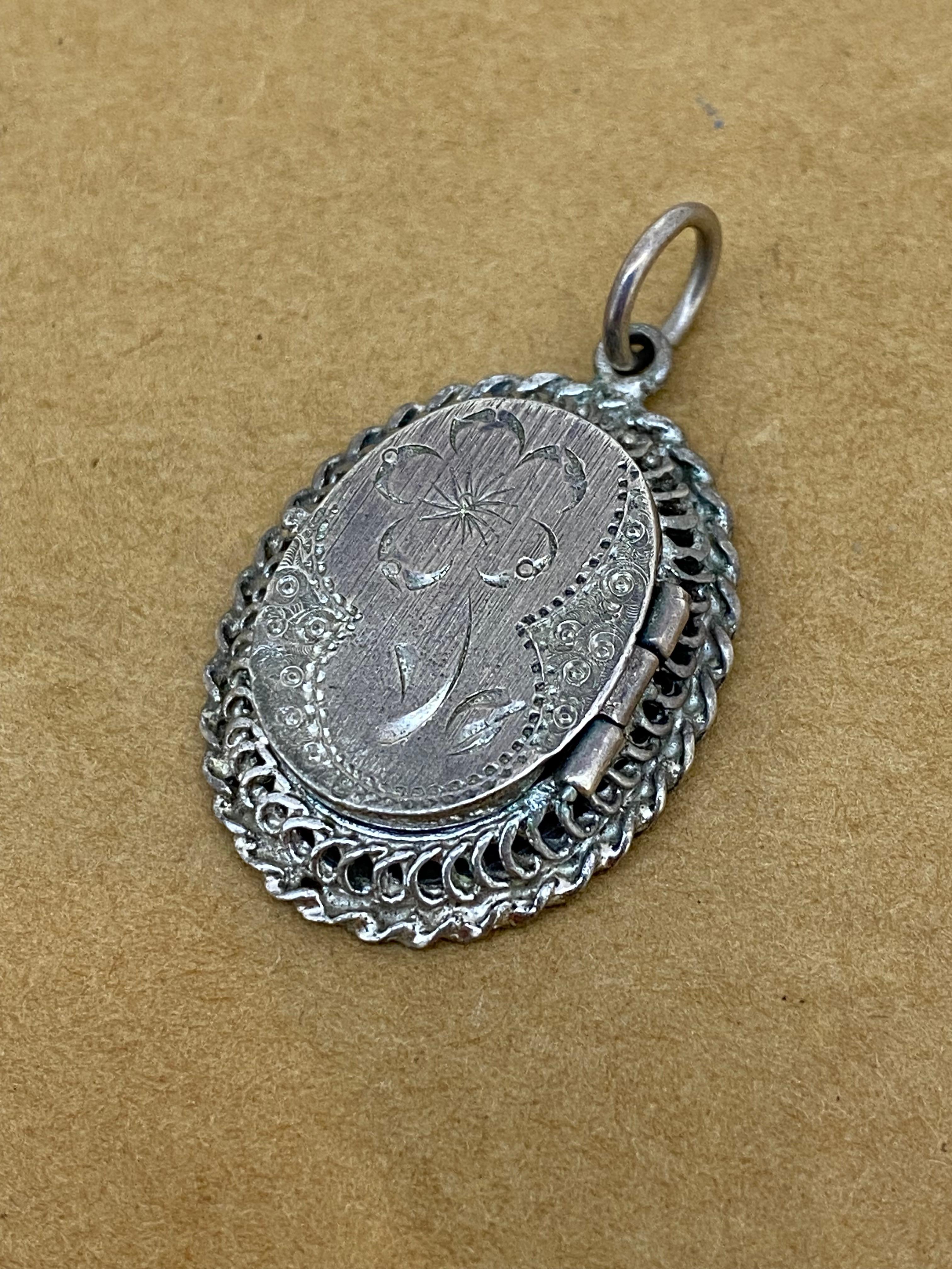 This Finely Engraved Vintage Oval Locket is hinged, 

opening up to reveal a photo compartment, 

that measures 18mm x 14mm

 

This intricate piece is in amazing condition, 

Meticulously crafted in 925 Sterling Silver  

 

With ornate beautifully