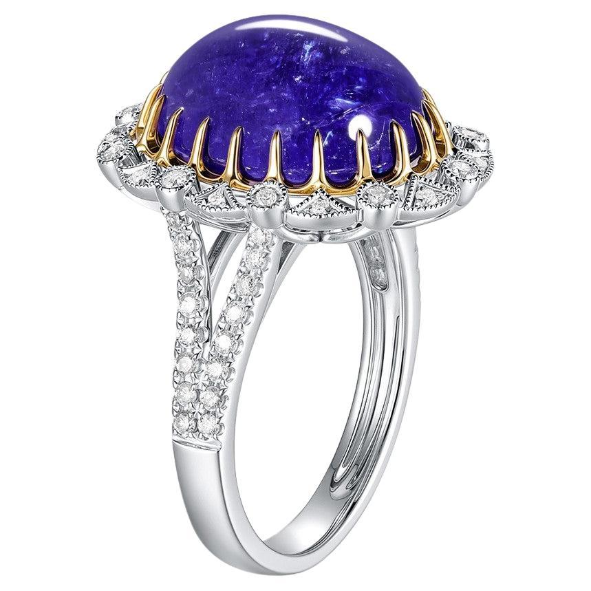 A masterpiece of elegance and bold design, this exceptional ring combines the cool brilliance of platinum with the warmth of 18K yellow gold. At its center is a mesmerizing 9.54-carat cabochon-cut tanzanite, known for its deep, oceanic blue-violet