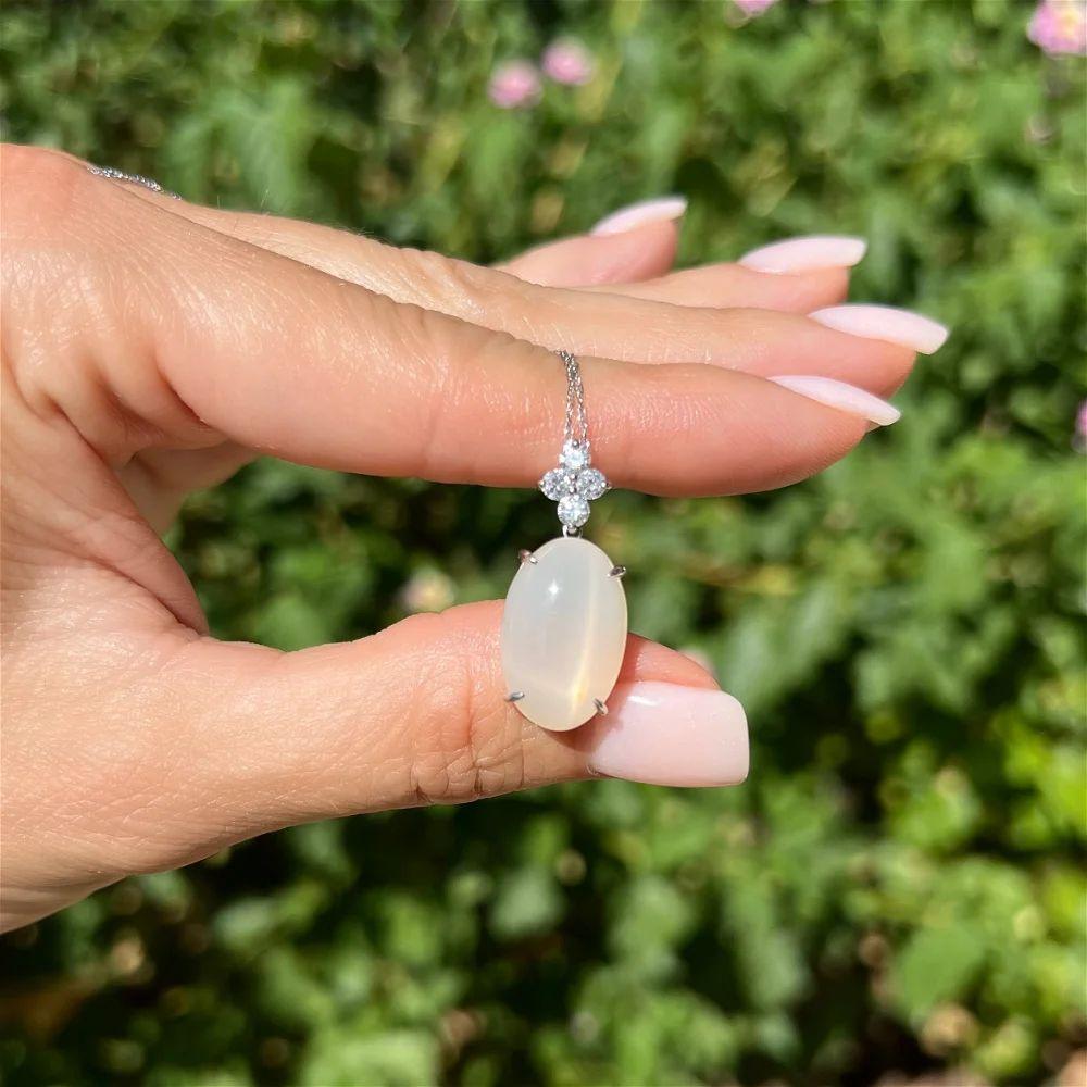 Simply Beautiful! Cabochon Moonstone and Diamond Drop Pendant Vintage Gold Necklace. Hand set with a Cabochon Moonstone, weighing approx. 9.81 Carat. Suspended from a Diamond cluster, approx. 0.40tcw. Hand crafted in 18K White Gold. Suspended from a
