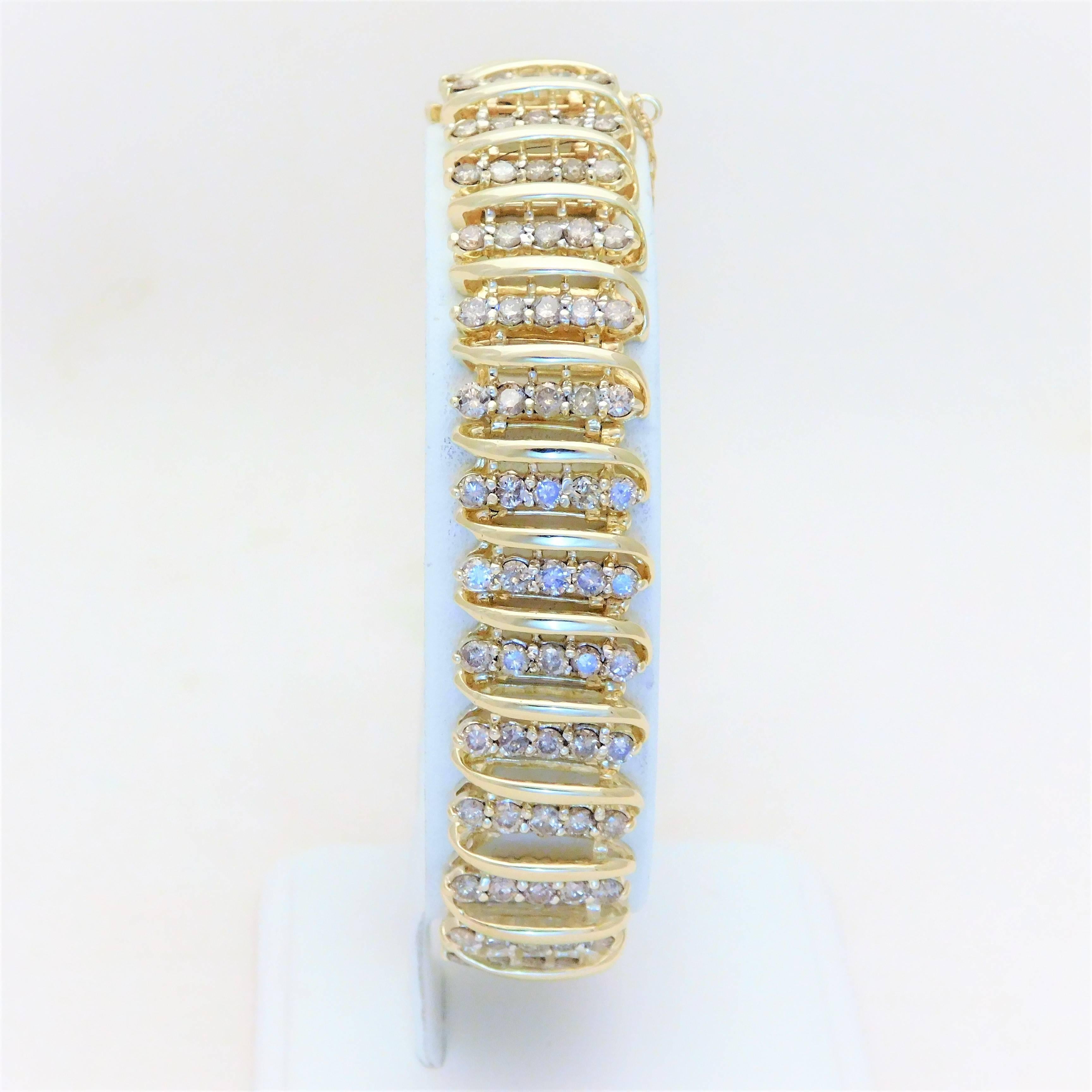 From a lovely New Orleans estate.  Circa 1965.  This chic bracelet has been crafted in solid 10k yellow gold.  It is masterfully jeweled with a total of 150 dazzling natural round brilliant-cut diamonds approximating 9ct in total weight.  This