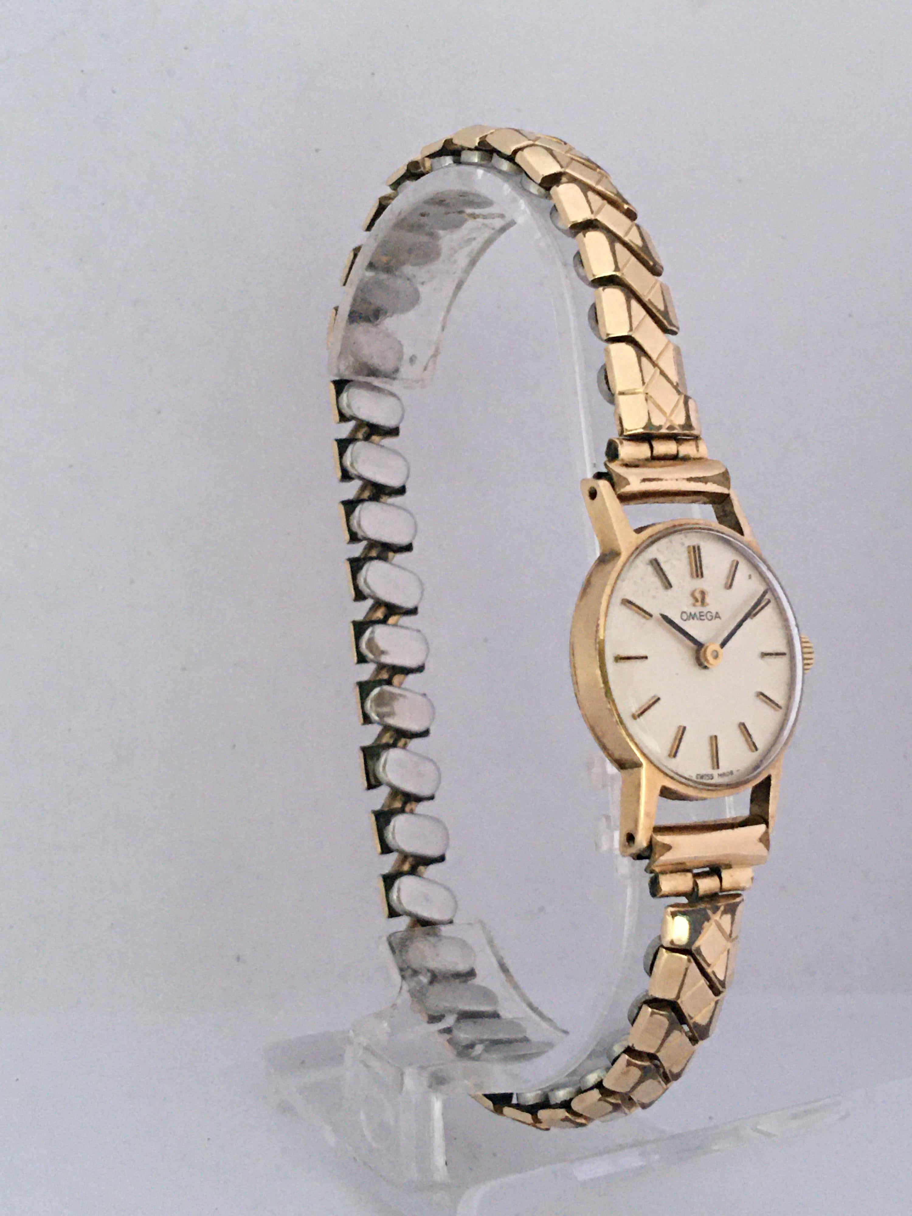 Omega 9ct lady's bracelet watch, Birmingham 1964, serial no. 221316xx, circular silvered dial with baton markers, signed cal. 620 17 jewel adjusted two positions signed Dennision case, gold plated expanding bracelet, 16.5gm, 19mm watch diameter.