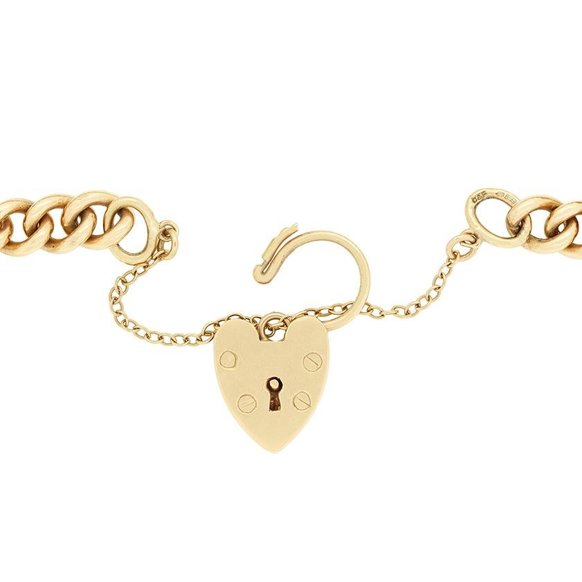 This 9 carat yellow gold bracelet dates to 1988 and features a love hear padlock at its centre. The Albert chain styled bracelet is 18cm in length, 7mm in width and weighs a total of 22.4 grams.

Metal: 9ct Yellow Gold
Age: 1988