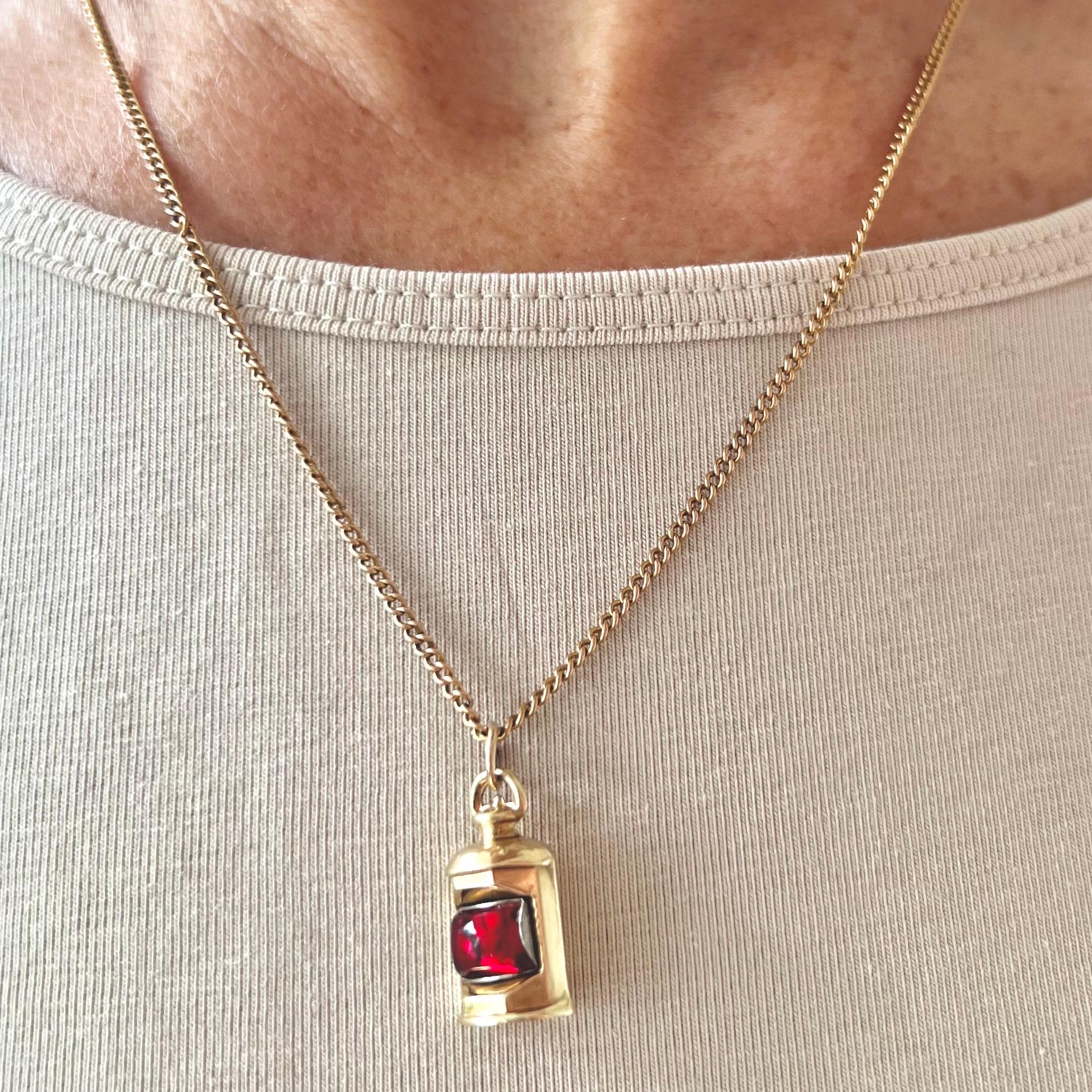 A vintage 9 karat yellow gold lantern charm pendant. The lantern is beautifully detailed and the is set with a red glass in the center which indicates the lit fuse of the lantern.

Collect your own charms as wearable memories, it has a symbolic and