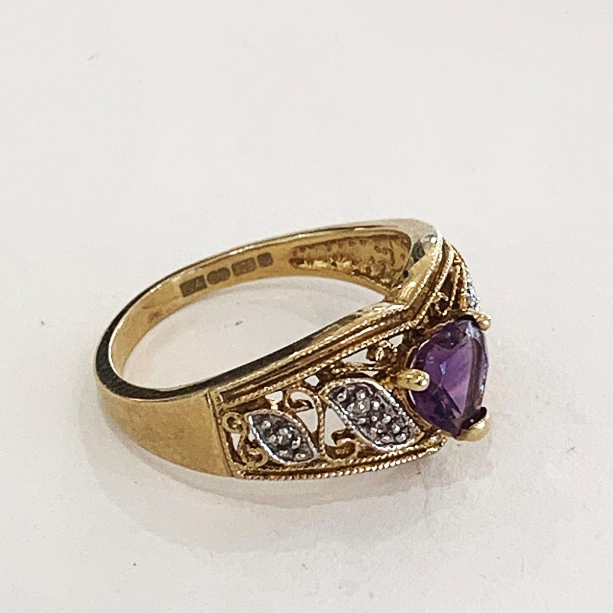 Vintage 9ct Gold Ring, set with Heart shape Amethyst with two leaves in white gold to each shoulder, set with one and two Diamonds  respectively. The band has internal hallmarks indicating England, and has 375 confirming the 9ct gold content plus