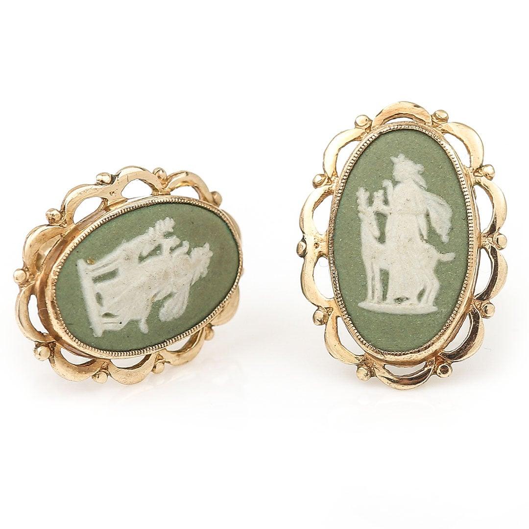 A very pretty pair of vintage 9ct gold oval Wedgwood Jasperware olive green cameo stud earrings dating from circa 1976. The central set cameo is an eye catching shade of pastel green, with the relief depiction of Diana/Artemis and the stag who was