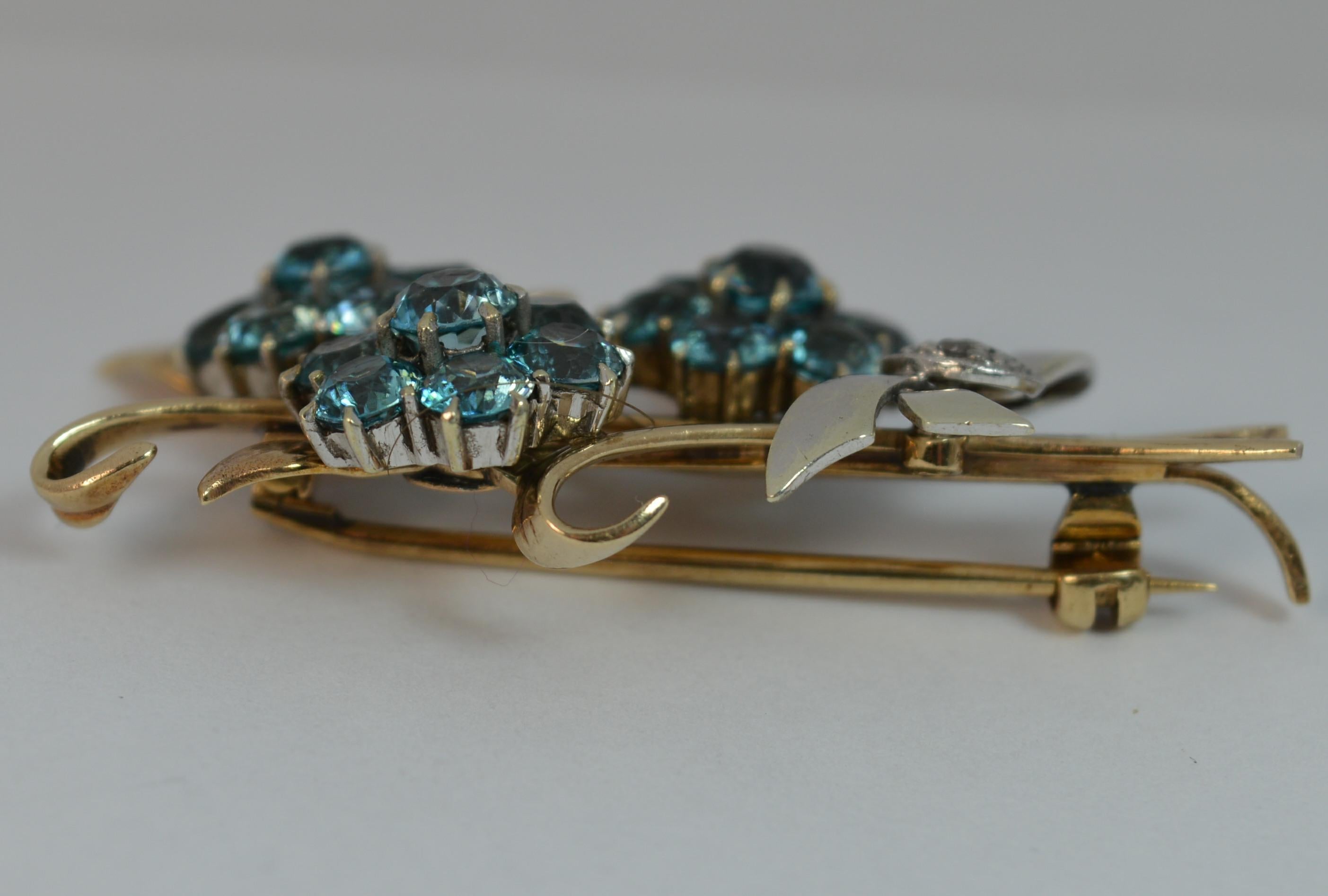 
A stunning true vintage brooch of floral spray design.

Solid 9 carat rose gold and platinum example.

Set with three clusters of round blue zircon stones forming flower heads with a bow ribbon to base set with little rose cut diamonds.


CONDITION