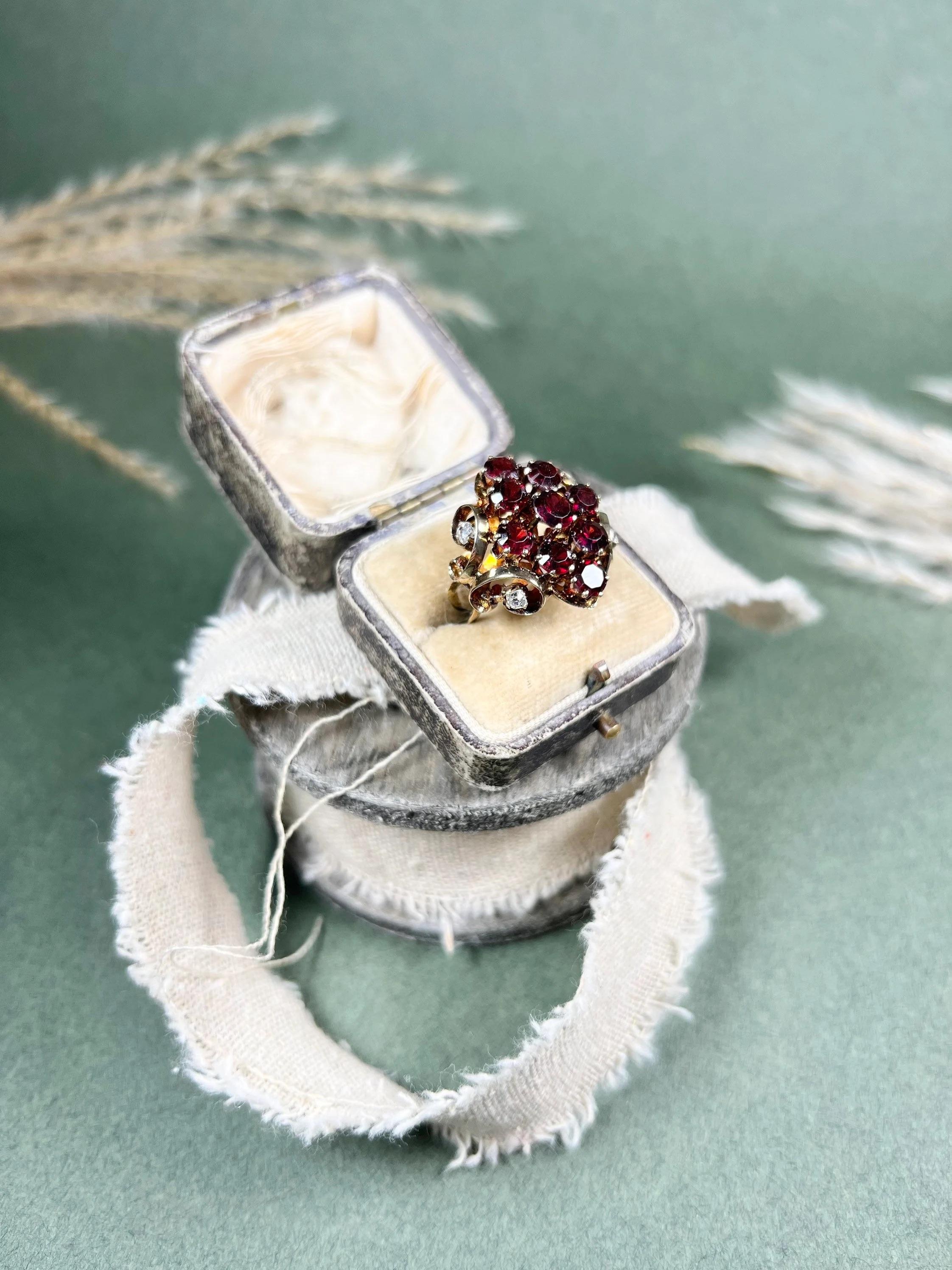 Vintage Garnet Ring 

9ct Rose Gold 

Circa 1970’s

Gorgeous, vintage garnet ring. Set with a large cluster of natural, faceted garnets. Mounted on scrolled shoulders, each set with two beautiful diamonds each side. Even the underneath is pretty!