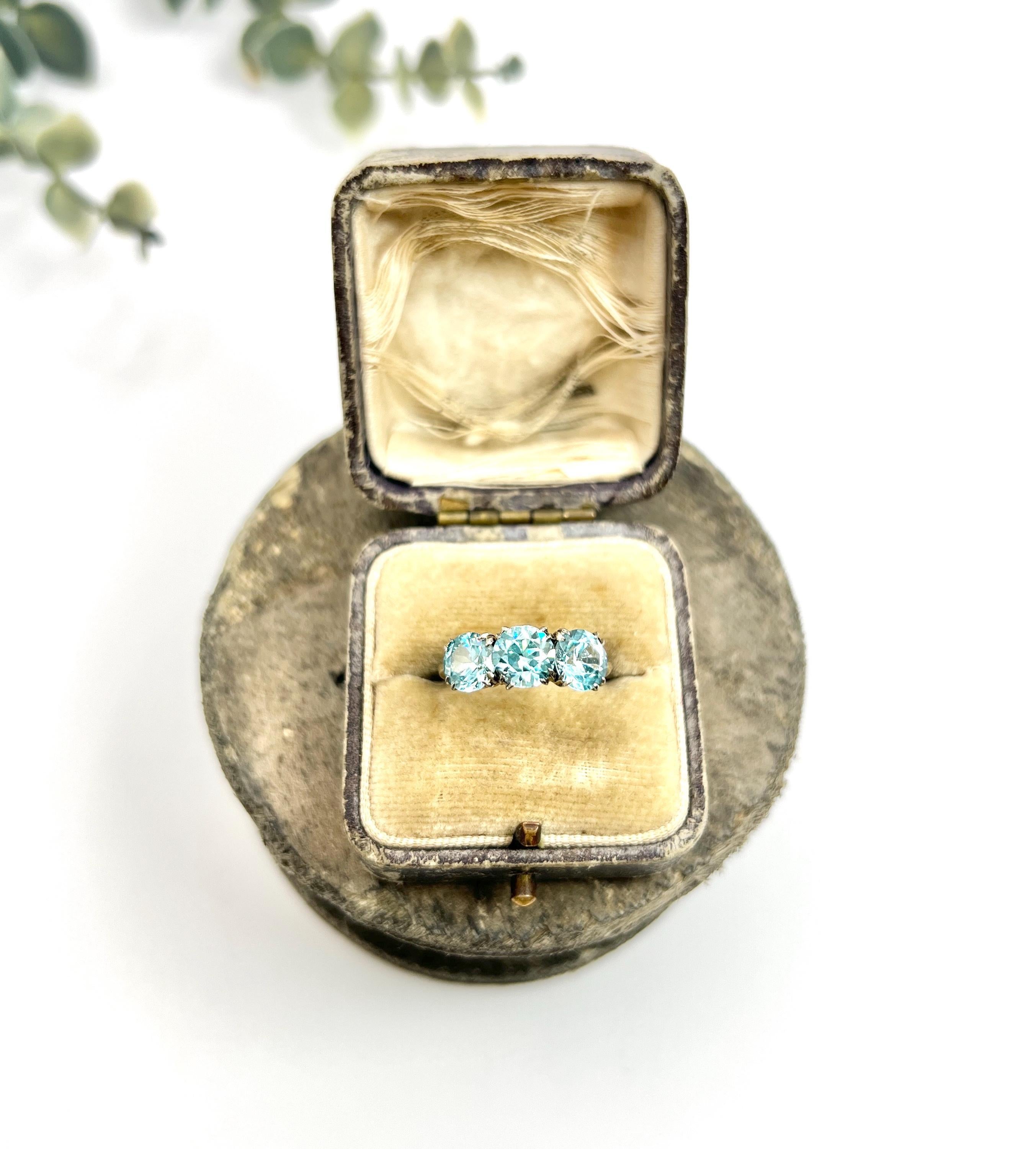 Vintage Zircon Ring 

9ct White Gold Stamped

Circa 1960s

Step into the elegance of the past with this stunning vintage trilogy ring, crafted from luxurious 9ct white gold. This exquisite piece features three vibrant blue zircon stones, each