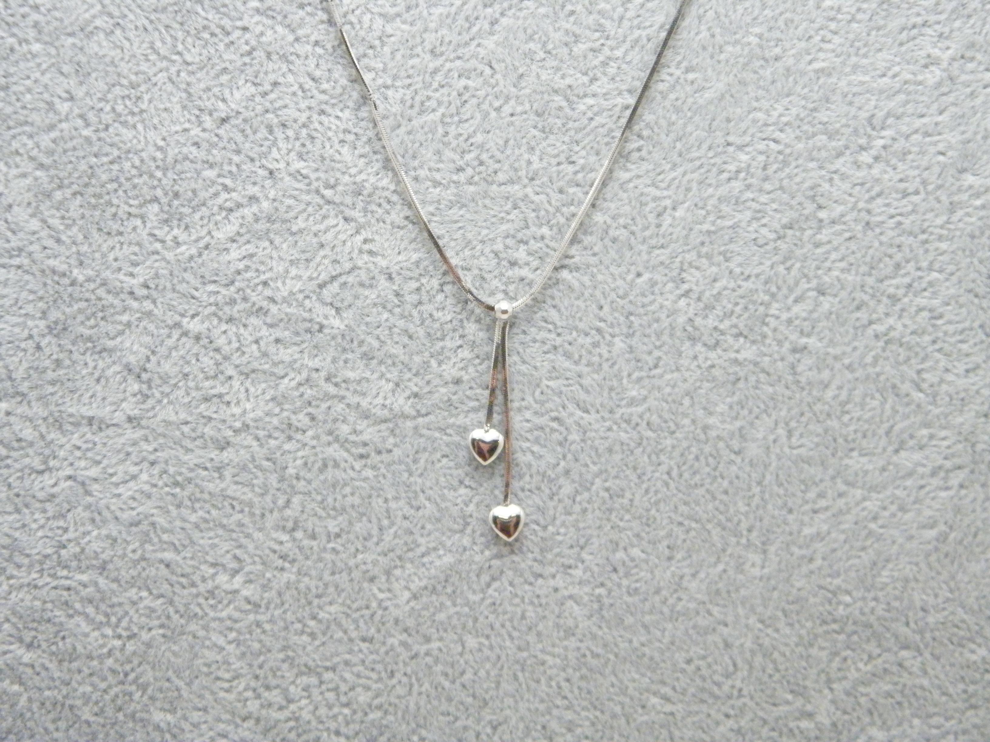 If you have landed on this page then you have an eye for beauty.

On offer is this gorgeous

9CT WHITE GOLD TWIN LARIAT HEART PENDANT NECKLACE

PENDANT DESCRIPTION
DETAILS
Material: Solid 9ct (375/000) white gold
Style: Classic Lariat style twin